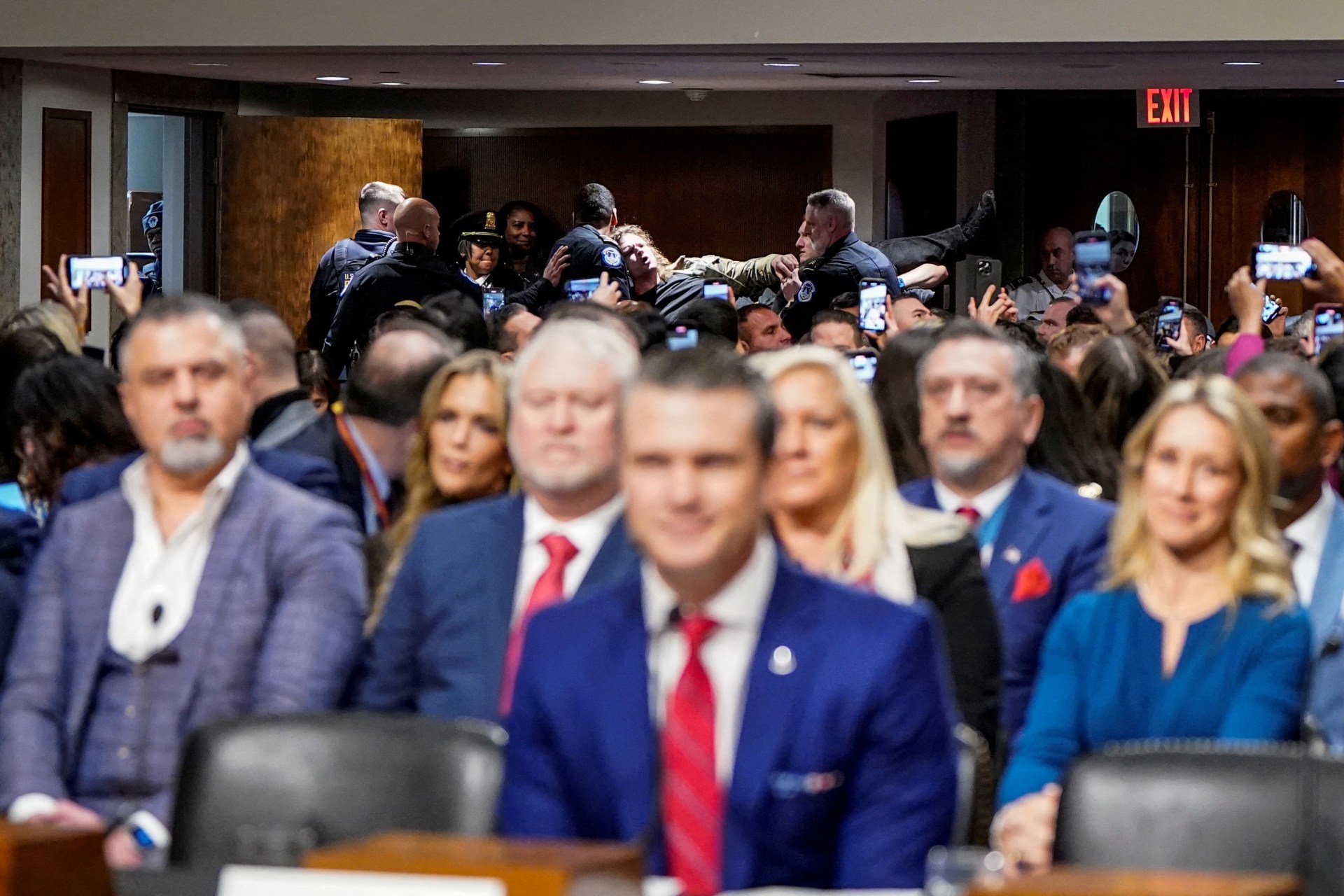 <p>Security personnel remove a protester as Pete Hegseth, U.S. President-elect Donald Trump’s nominee to be secretary of defense, testifies before a Senate Committee on Armed Services confirmation hearing on Capitol Hill in Washington, U.S., January 14, 2025</p>