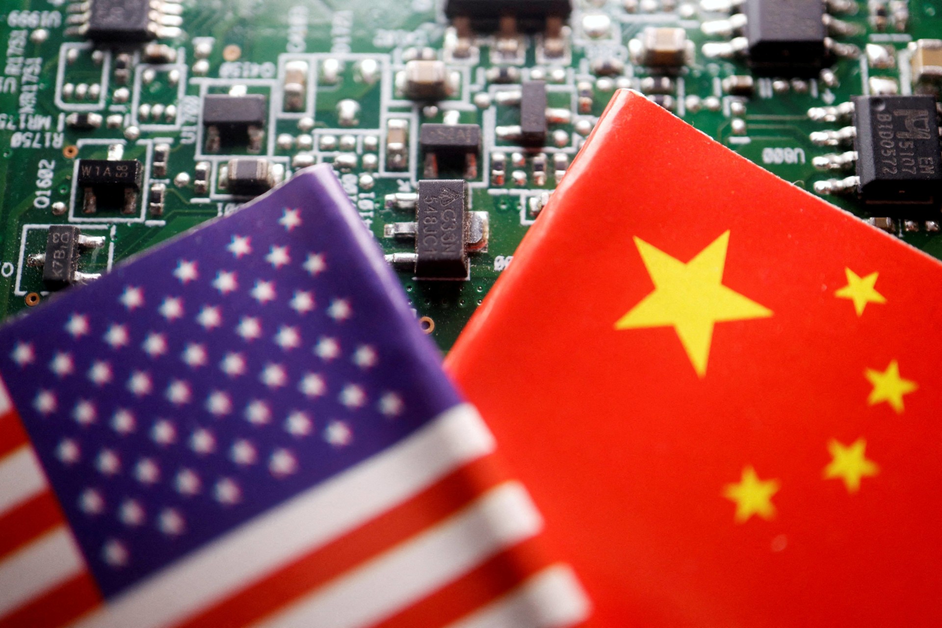 <p>Flags of China and the United States are displayed on a printed circuit board with semiconductor chips, in this illustration picture taken on February 17, 2023</p>