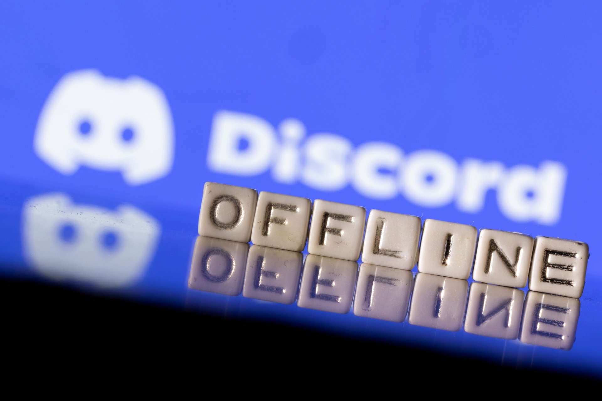 <p>Plastic letters arranged to read “Offline” are placed in front of the Discord logo in this illustration taken March 9, 2022.</p>