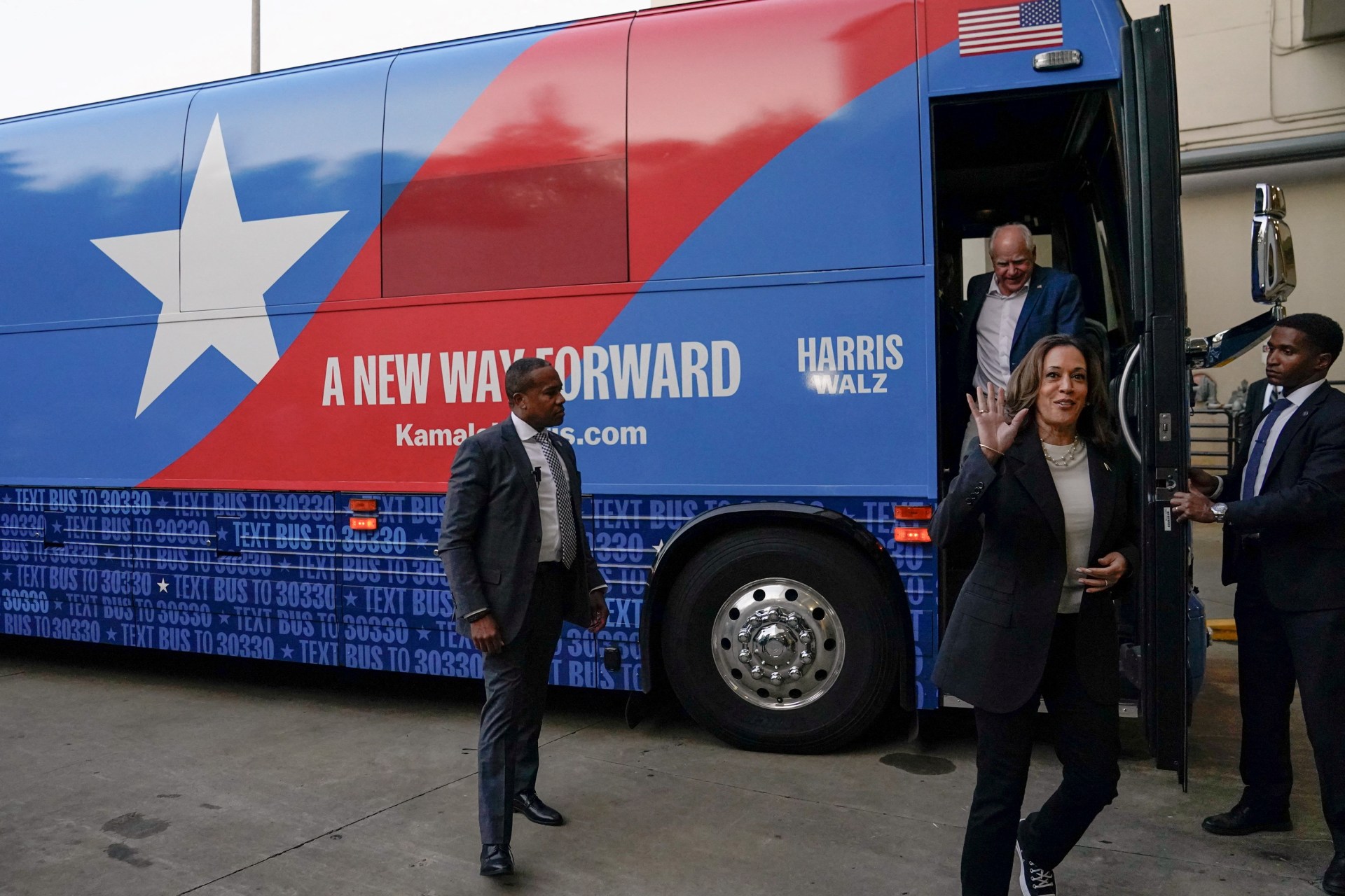 <p>Vice President Kamala Harris and her running mate Governor Tim Walz step off a campaign bus in Savannah, Georgia, on August 28, 2024. </p>
