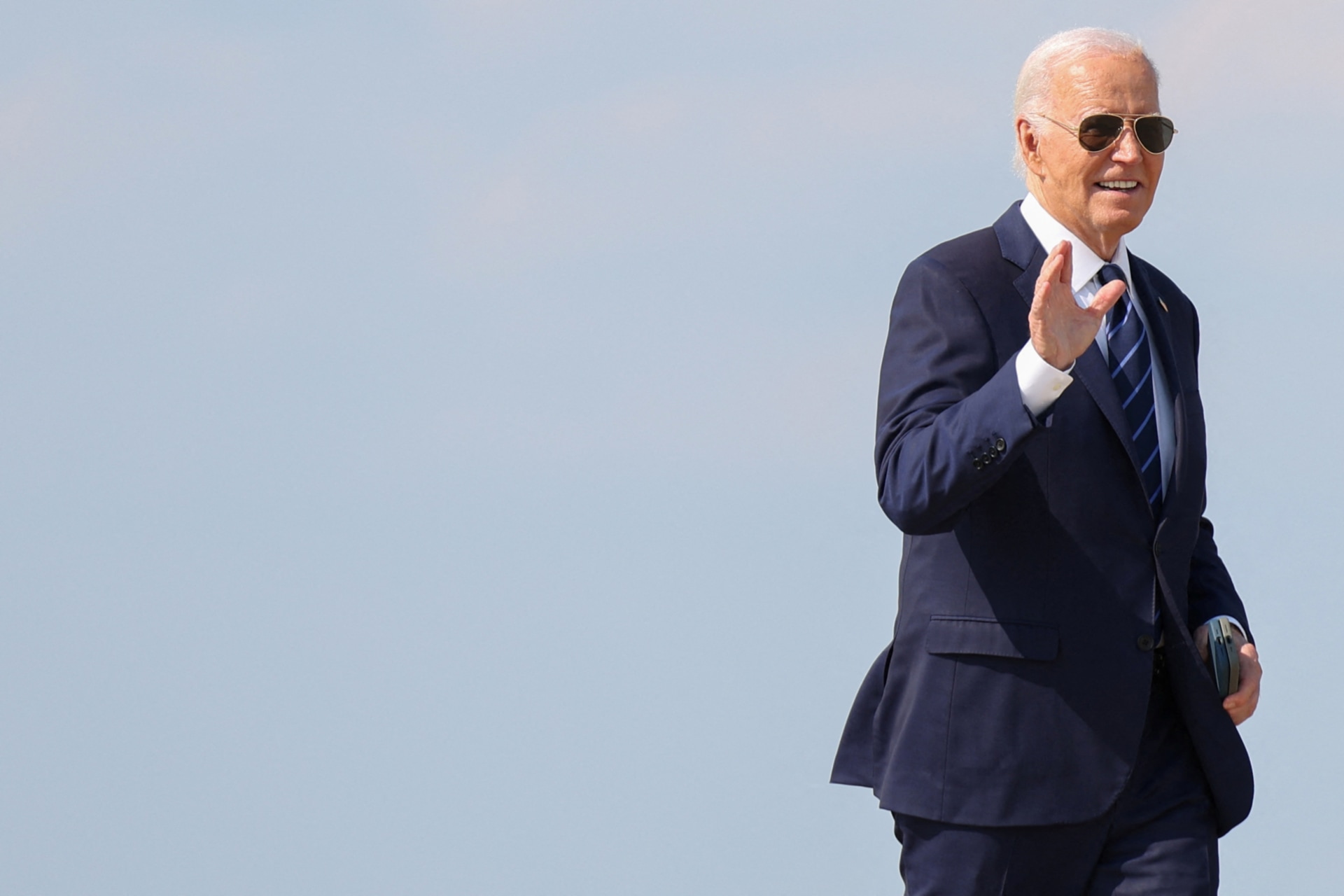 <p>President Joe Biden waves to journalists before boarding Air Force One at Joint Base Andrews in Maryland on July 15, 2024.</p>
