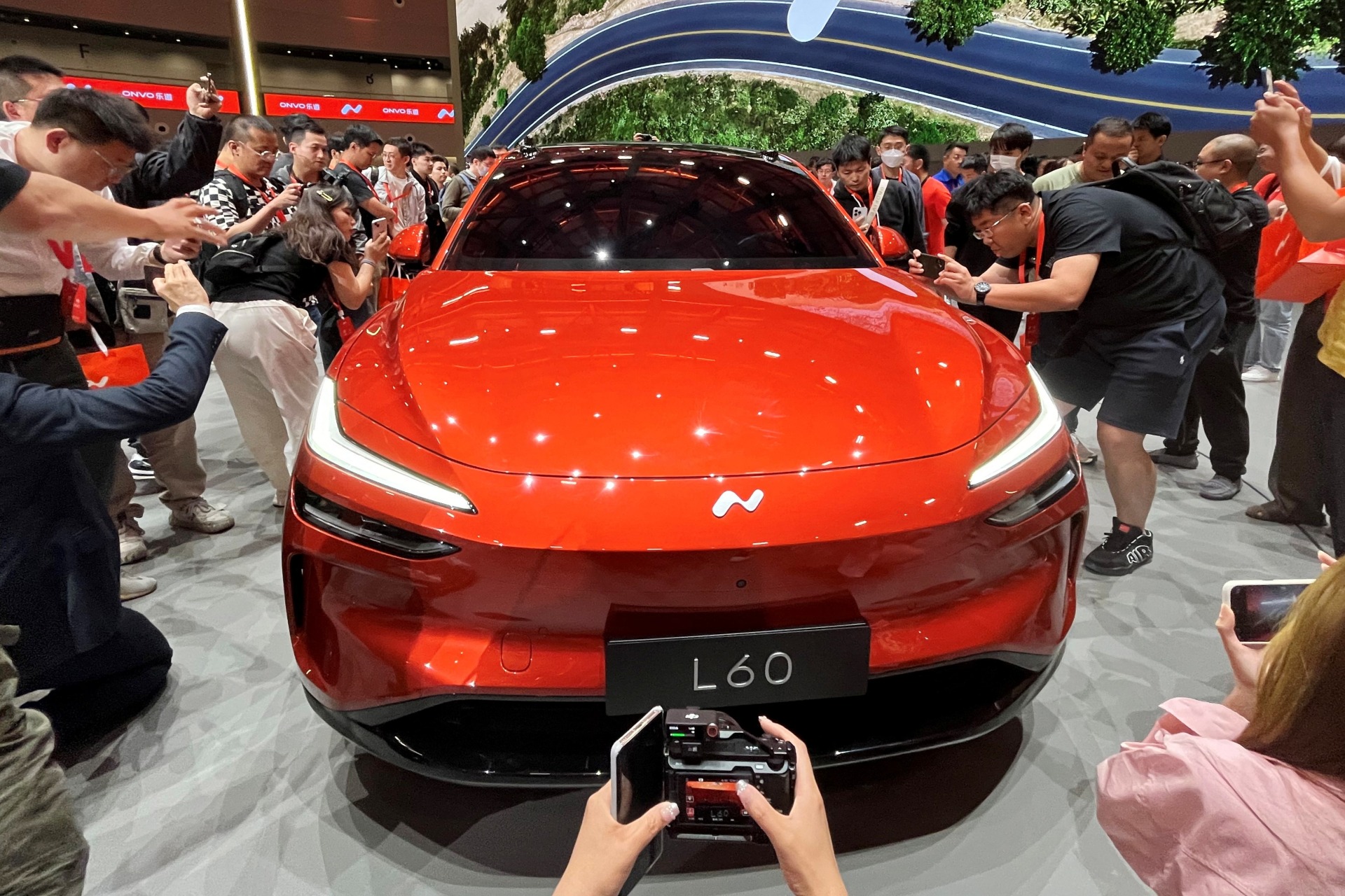 <p>People look at the newly unveiled Onvo L60 SUV, the first vehicle of Chinese electric vehicle (EV) maker Nio’s new lower-priced brand.</p>
