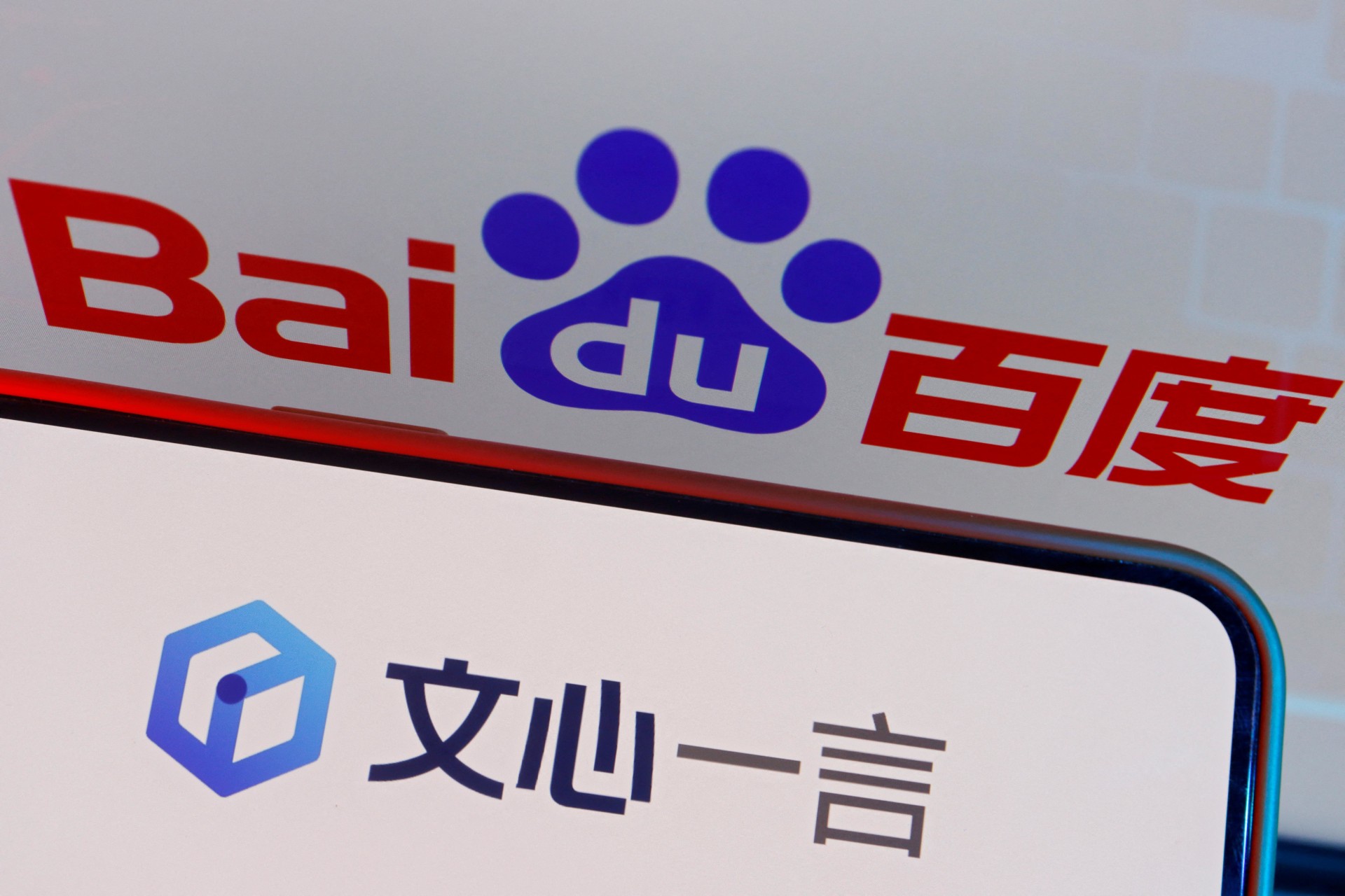 <p>The logo of Baidu’s AI chatbot Ernie Bot is displayed near a screen showing the Baidu logo, in this illustration picture taken June 28, 2023</p>