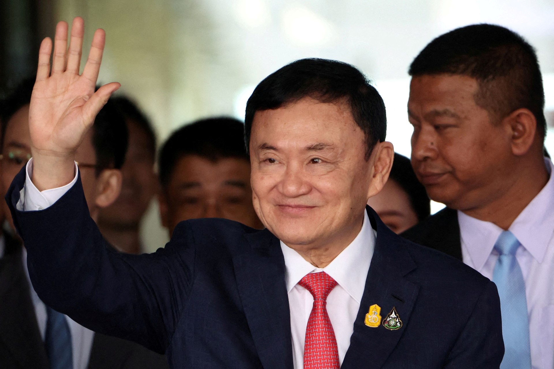 <p>Former Thai Prime Minister Thaksin Shinawatra, who is expected to be arrested upon his return as he ends almost two decades of self-imposed exile, waves at Don Mueang airport in Bangkok, Thailand, on August 22, 2023.</p>

