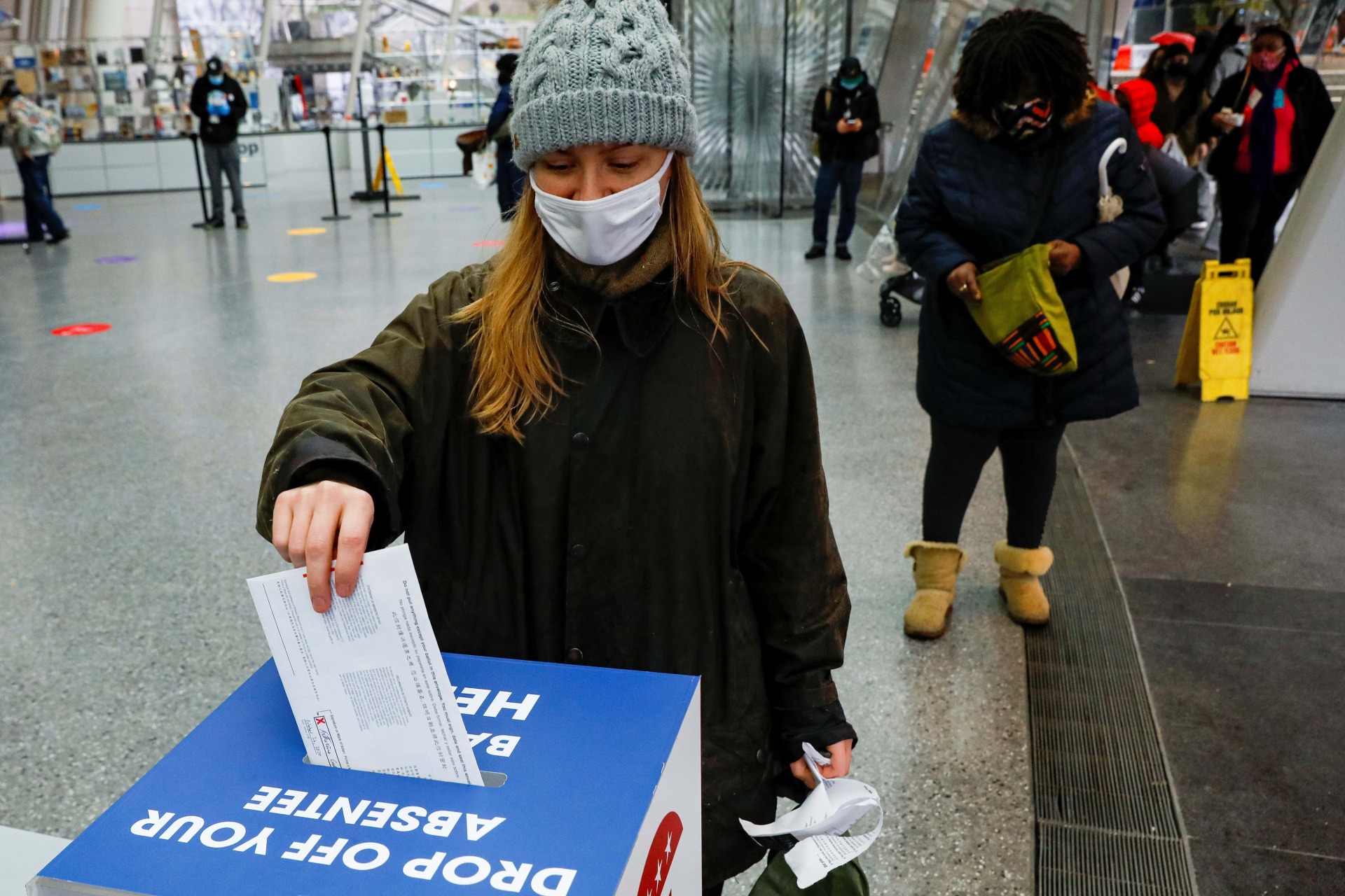 <p>A voter drops off her absentee ballot at a drop box at the Brooklyn Museum in the Brooklyn borough of New York City, New York on October 29, 2020.</p>