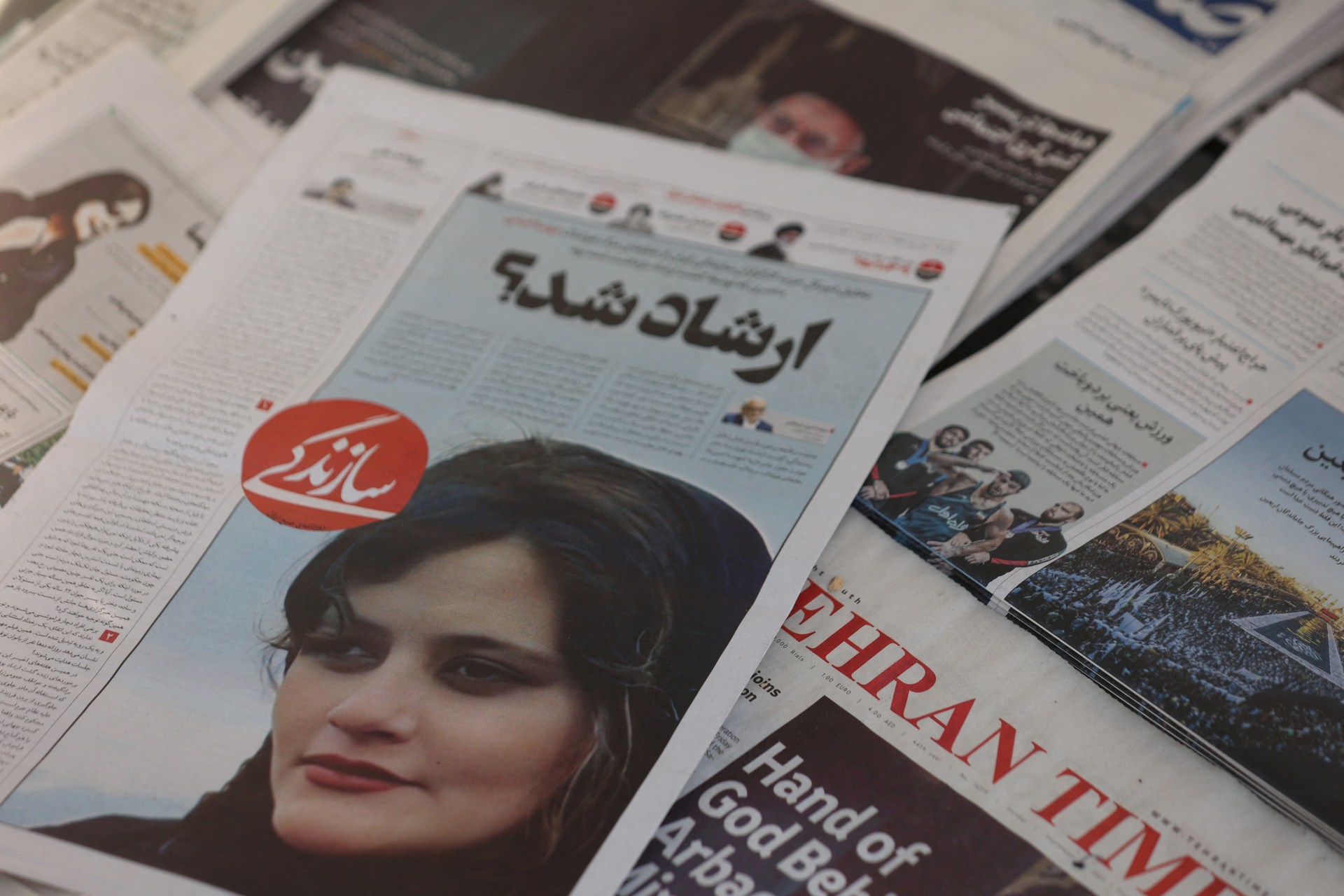 <p>A newspaper with a cover picture of Mahsa Amini, a woman who died after being arrested by the Islamic republic’s “morality police” is seen in Tehran, Iran September 18, 2022.</p>
