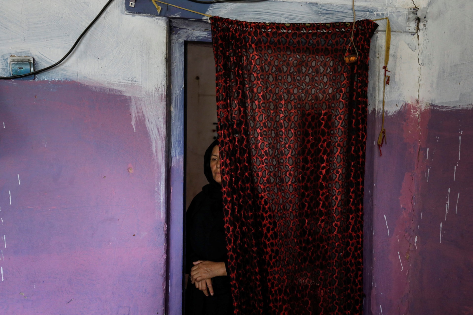 <p>Golestan Safari, 45, poses for a photograph in her house in Kabul.</p>