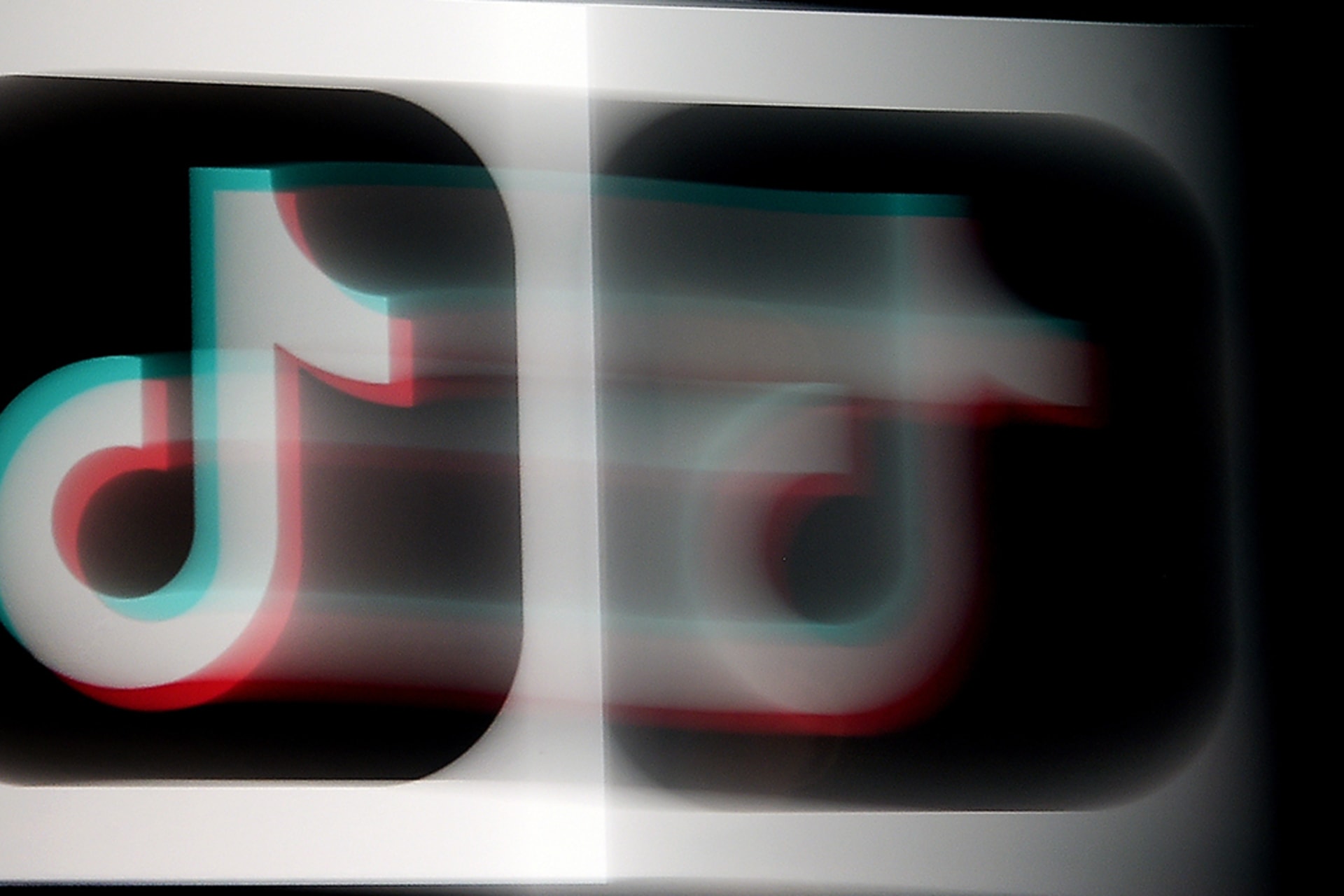 <p>The TikTok logo appears on an iPhone screen.</p>
