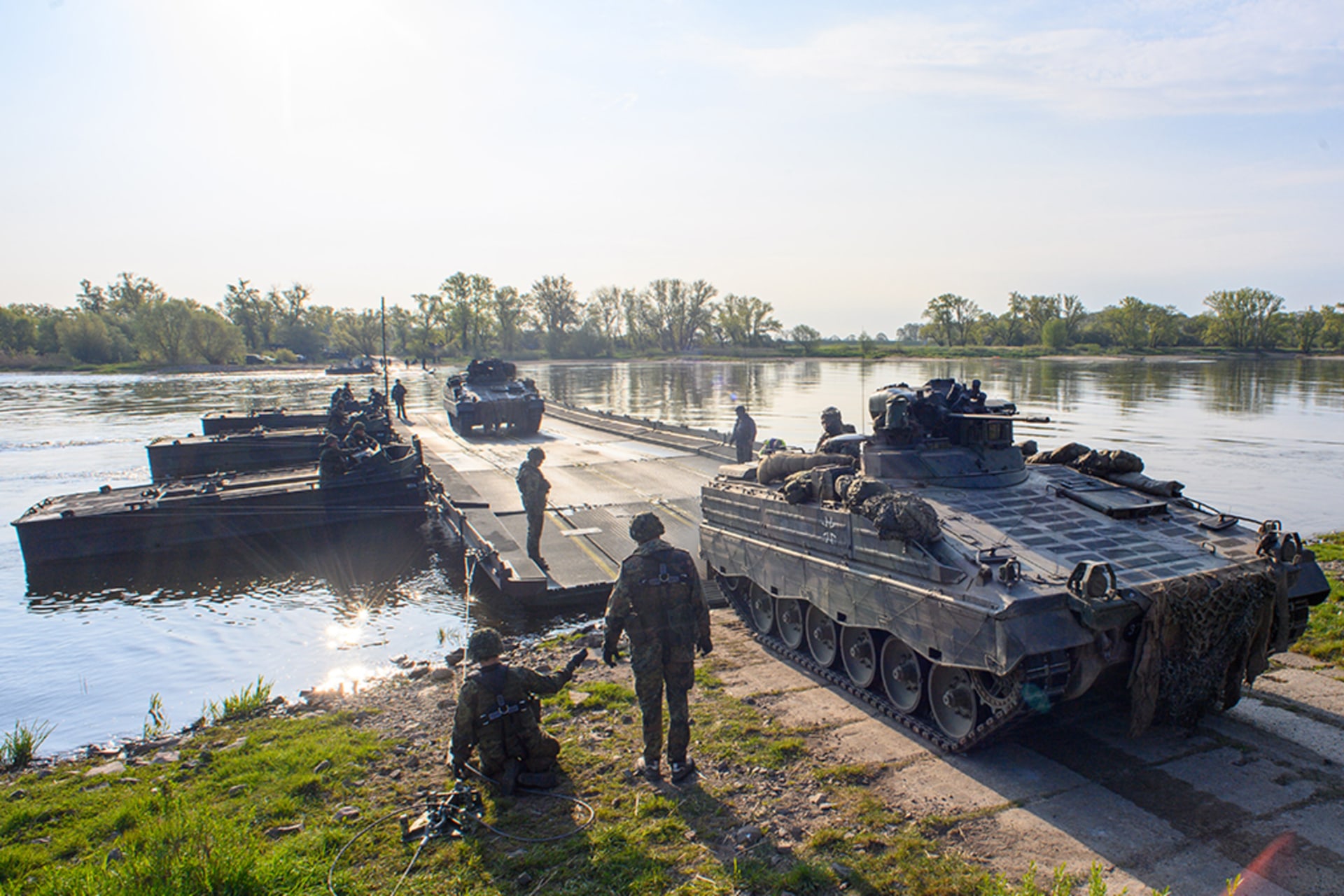 <p>A Marder infantry fighting vehicle rolls ashore from a floating bridge in Saxony, Germany.. </p>
