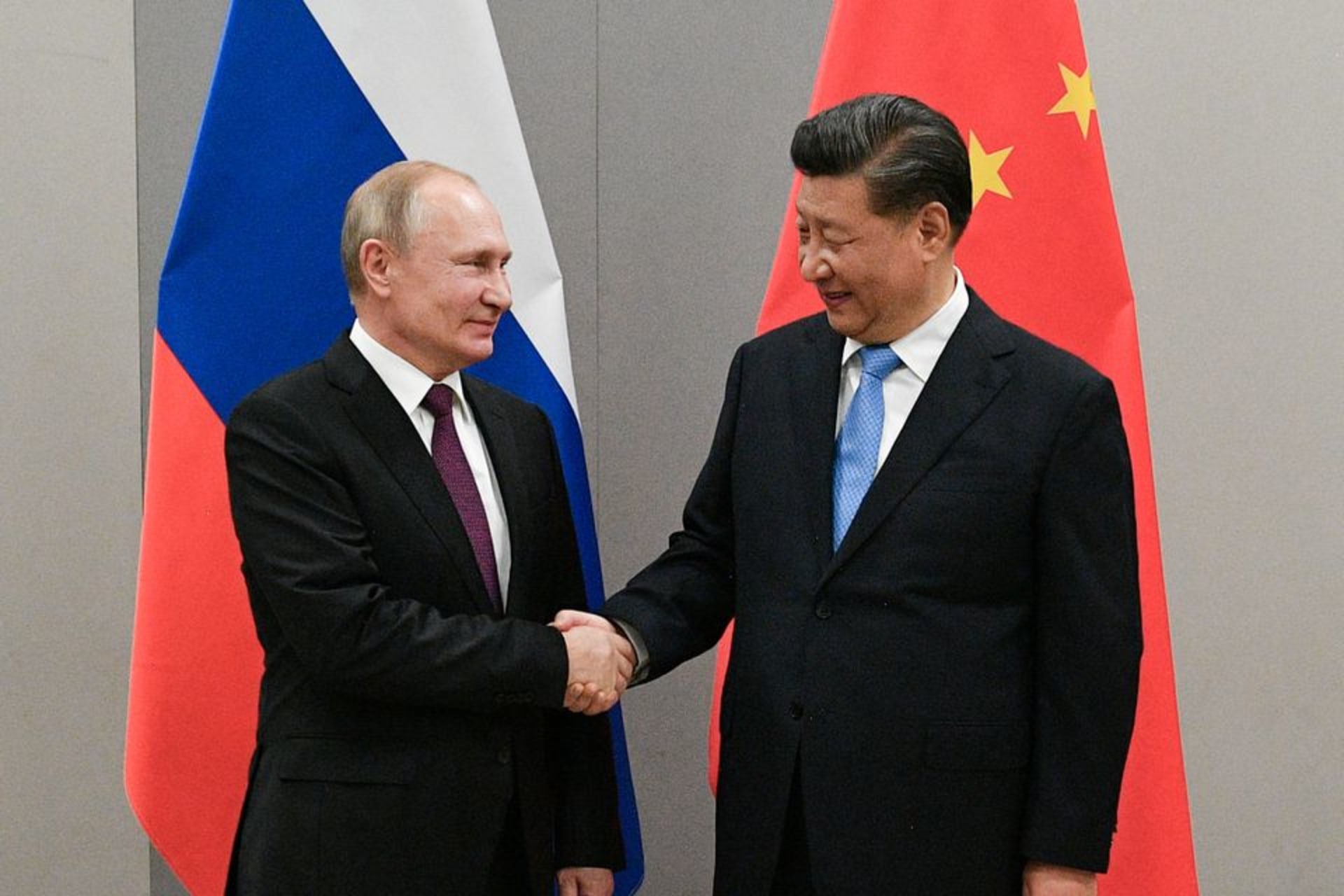 <p>Russian President Vladimir Putin and Chinese President Xi Jinping shake hands after meeting on the sidelines of a summit in Brasilia in November 2019.</p>