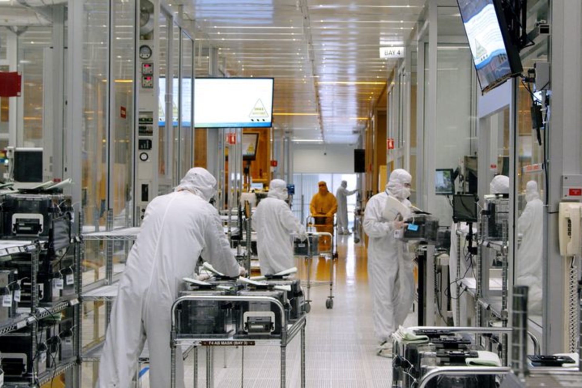 <p>Workers move equipment inside the SkyWater Technology Inc. semiconductor plant in July 2022.</p>