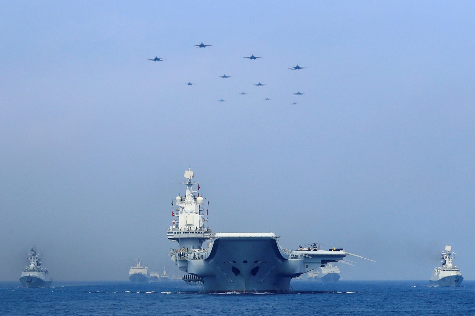 <p>Ships from the People’s Liberation Army Navy sail during 2018 live fire exercises in the Taiwan Strait.</p>
