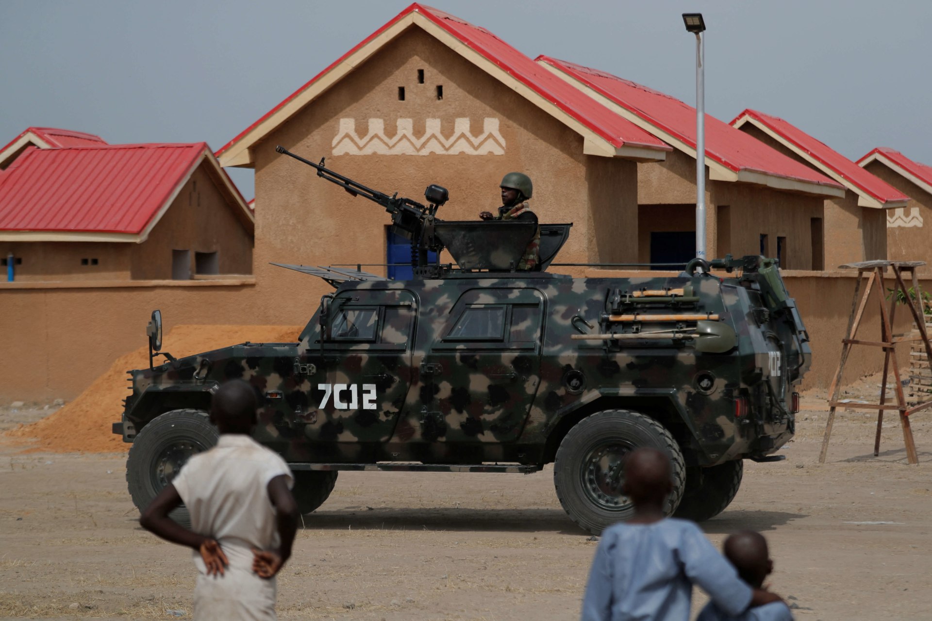 <p>An armored vehicle of Nigerian Security Forces drives by newly built homes which were destroyed by Boko Haram armed militants in 2015 in Ngarannam, Borno State, Nigeria on October 21, 2022.</p>

