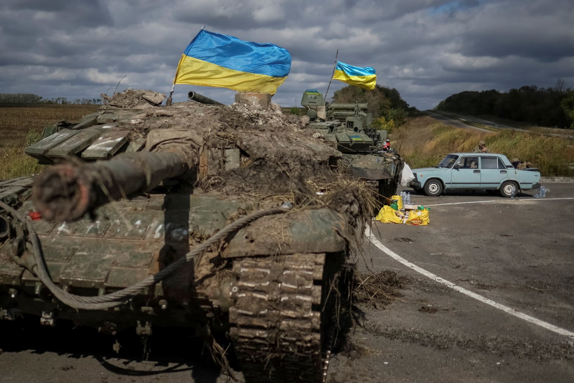 <p>Ukranian flags fly above captured Russian tanks on September 19, 2022, near the town of Izium.</p>