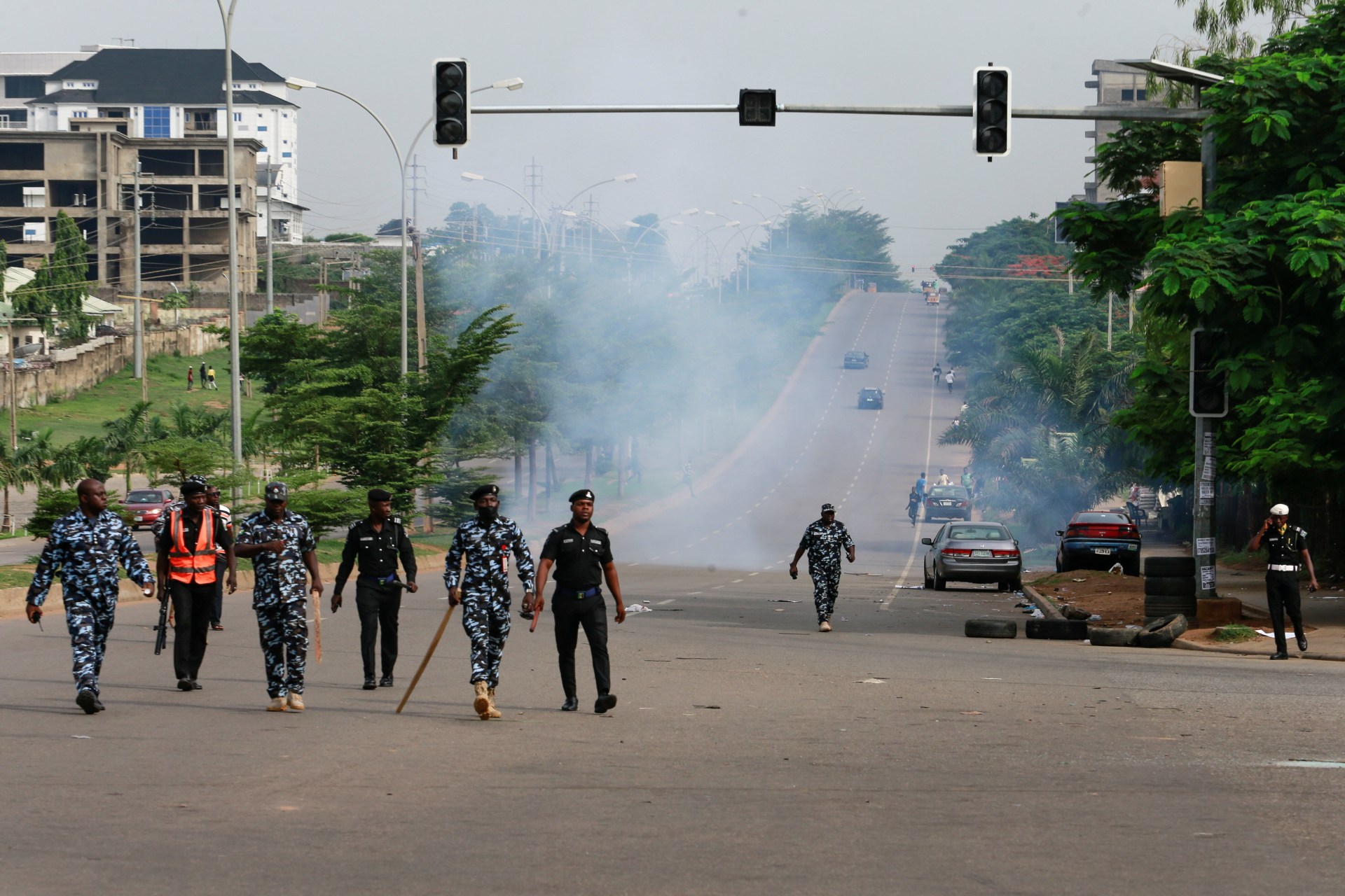 <p>Members of the Nigeria police force walk after chasing protesters away during a June 12 Democracy Day rally in Abuja, Nigeria on June 12, 2021.</p>