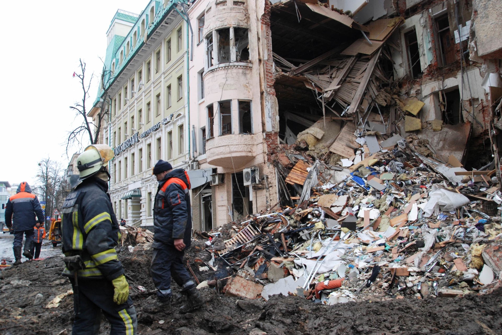 <p>Rescue workers stand near a heavily damaged building, amid Russia’s invasion of Ukraine, in Kharkiv, Ukraine on March 14, 2022.</p>
