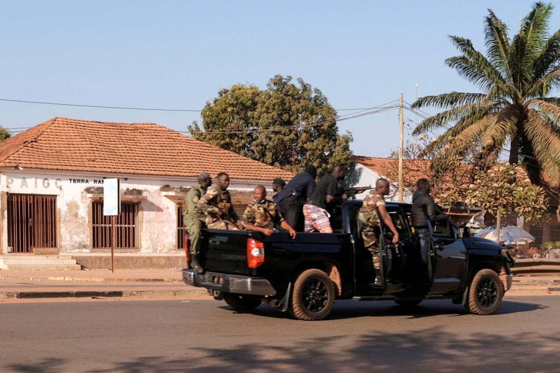 <p>Armed soldiers move on the main artery of the capital after heavy gunfire around the presidential palace in Bissau, Guinea-Bissau on February 1, 2022.</p>