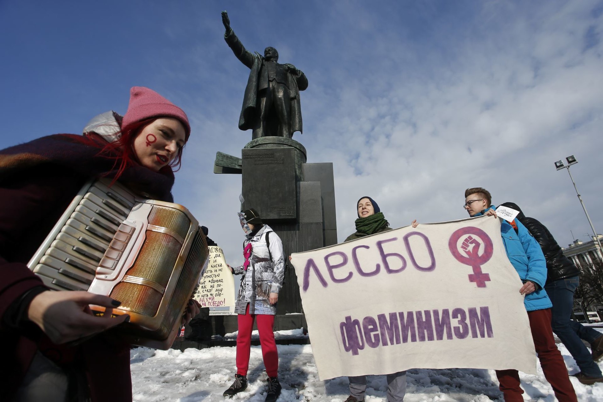 <p>Participants attend a rally, held to support women’s rights and to protest against violence towards women, with a monument to Soviet state founder Vladimir Lenin seen in the background, in Saint Petersburg, Russia March 8, 2019. </p>
