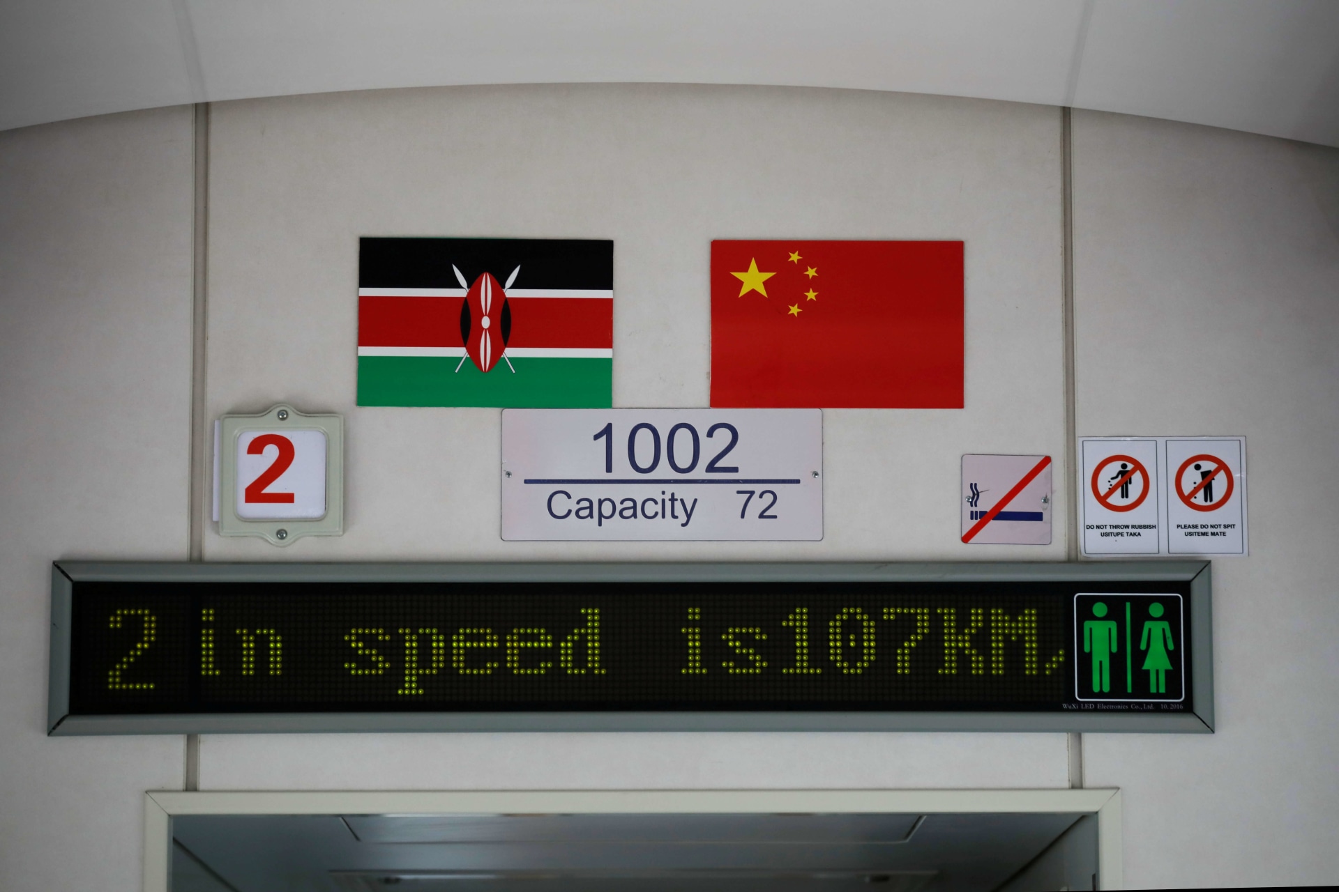 <p>The Kenyan and Chinese national flags hang on the wall of an SGR train traveling from Nairobi to Mombasa, Kenya, on October 22, 2019.</p>