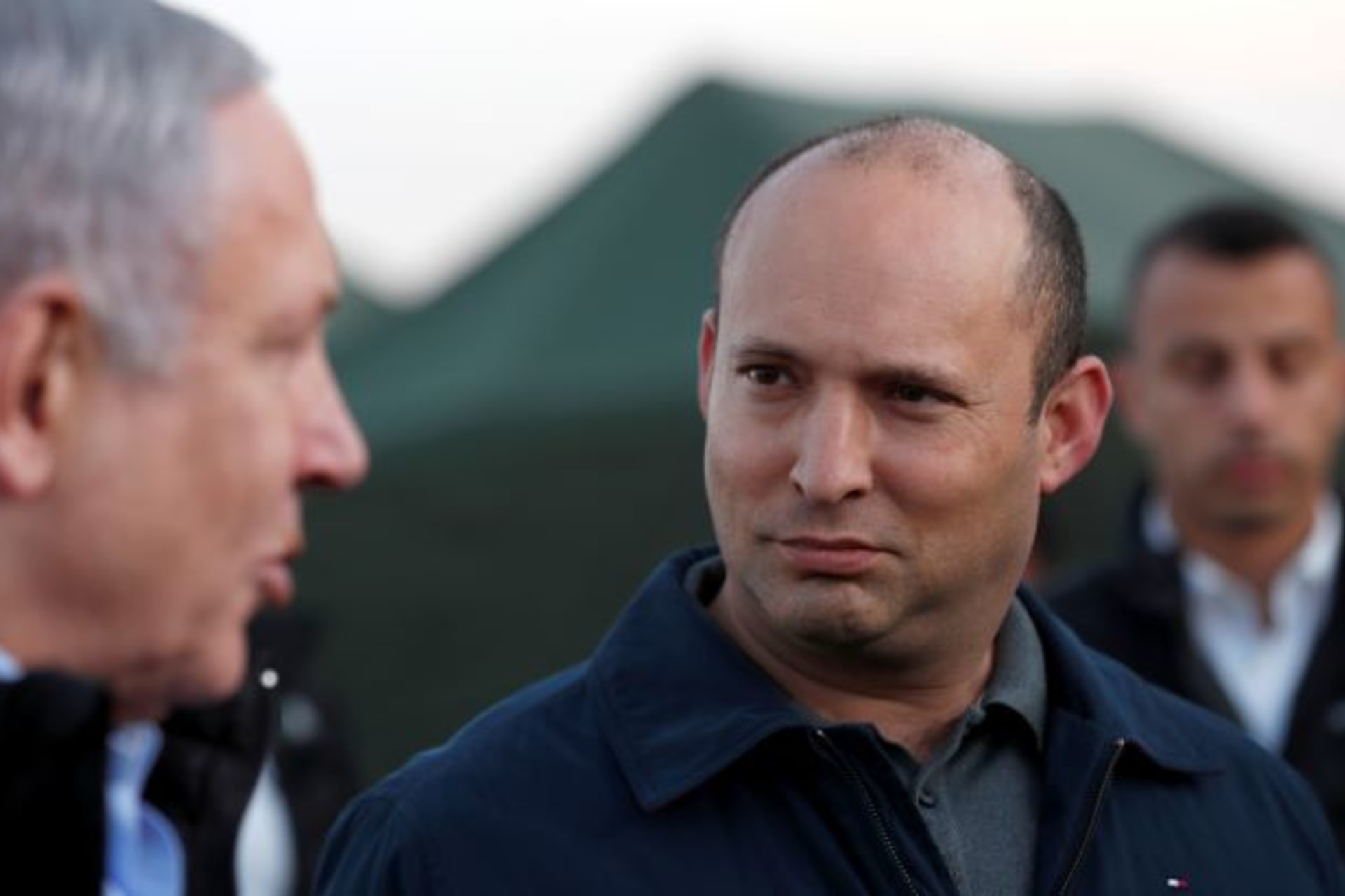 <p>Israeli Defense Minister Naftali Bennett looks at Prime Minister Benjamin Netanyahu during a visit to an Israeli army base in the Israeli-occupied Golan Heights, November 24, 2019.</p>