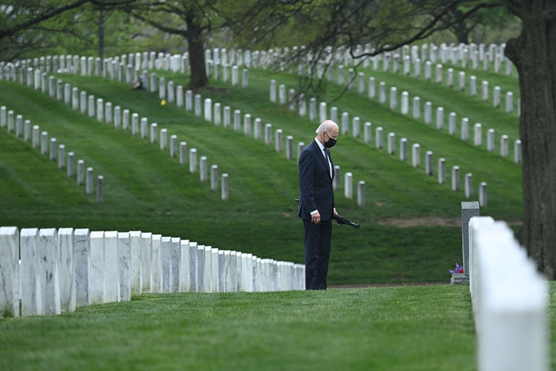 <p>U.S. President Joe Biden walks through Arlington National Cemetery in April 2021 to honor fallen veterans of the Afghan conflict.</p>