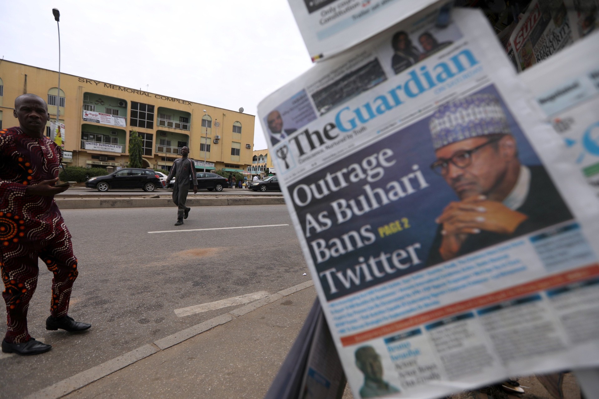 <p>A man looks at newspapers at a newsstand in Abuja, Nigeria on June 5, 2021.</p>
