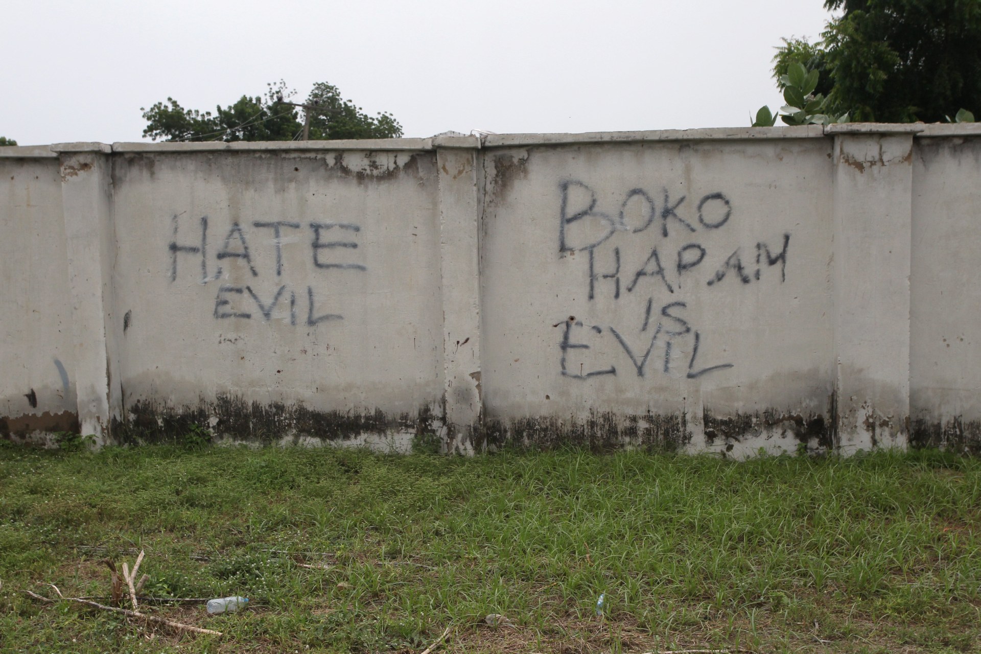 <p>Writings describing Boko Haram are seen on the wall along a street in Bama, in Borno, Nigeria on August 31, 2016.</p>