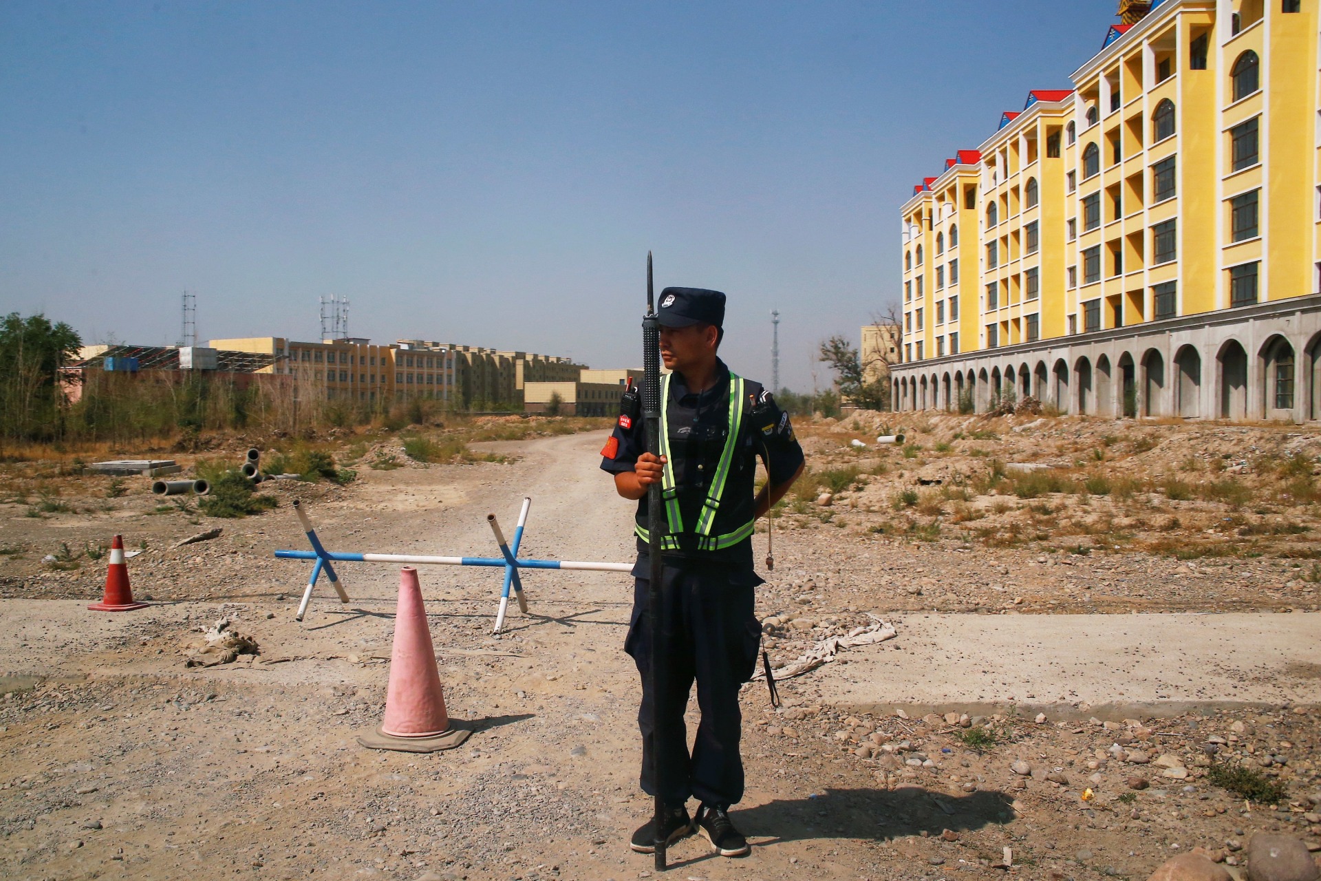 <p>A Chinese police officer takes his position by the road near what is officially called a vocational education centre in Yining in Xinjiang Uighur Autonomous Region, China on September 4, 2018.</p>
