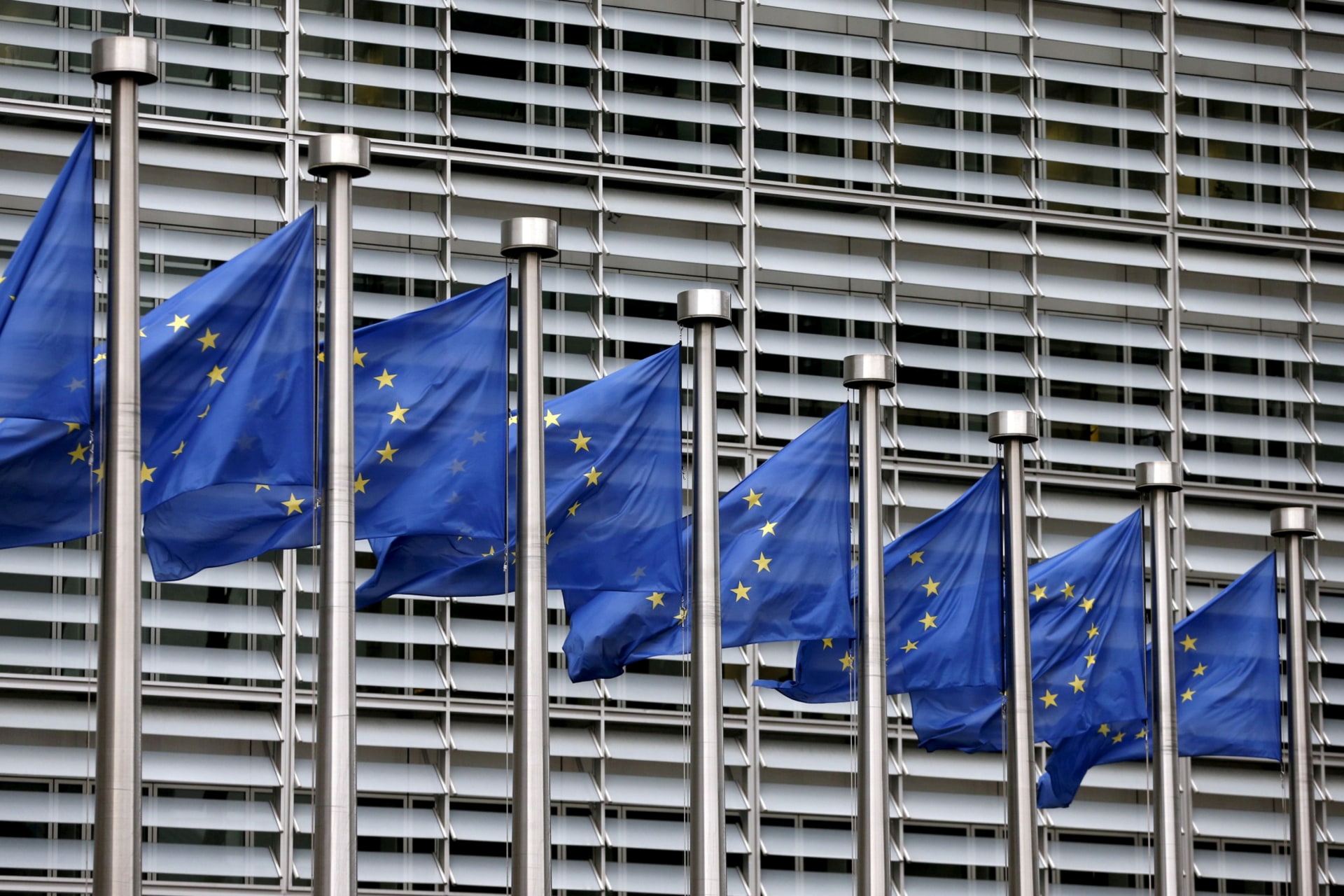 <p>European Union flags flutter outside the EU Commission headquarters in Brussels, Belgium.</p>
