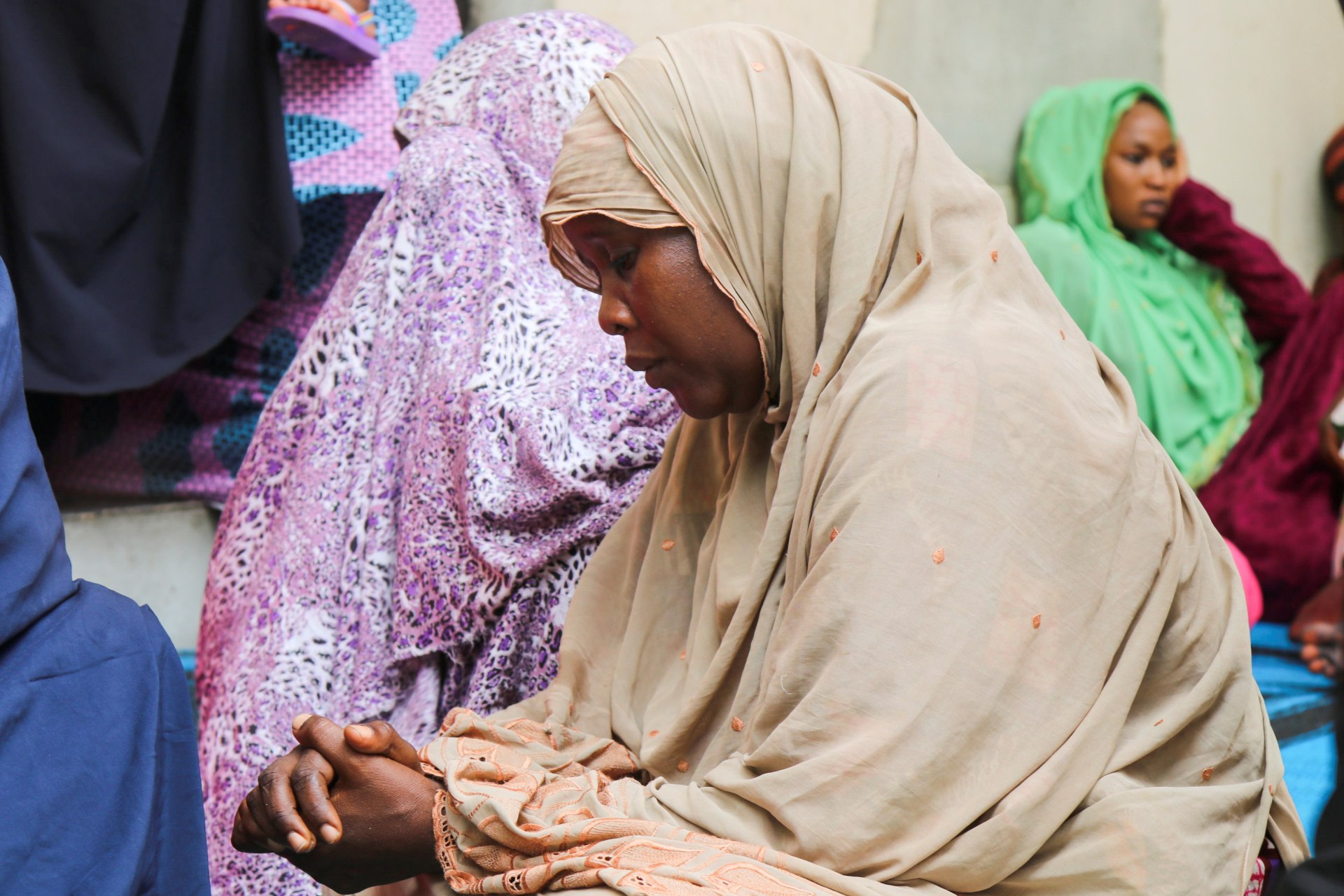 <p>Women mourn the death of aid workers who were executed by Islamist militants, in the northeast Nigerian city of Maiduguri, Nigeria on July 23, 2020.</p>