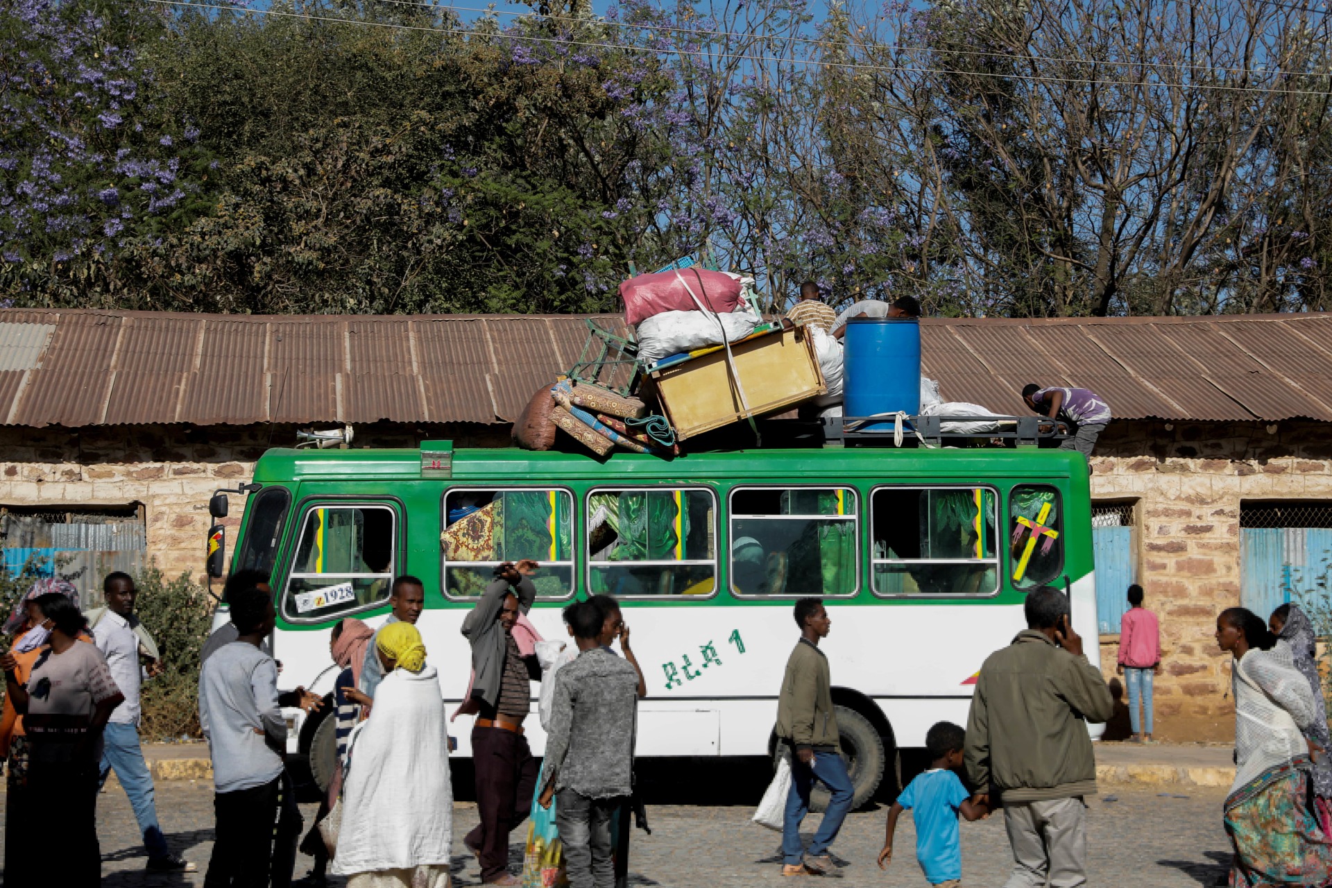 <p>A bus carrying displaced people arrives at the Tsehaye primary school, which was turned into a temporary shelter for people displaced by conflict, in the town of Shire, Tigray region, Ethiopia, March 14, 2021.</p>