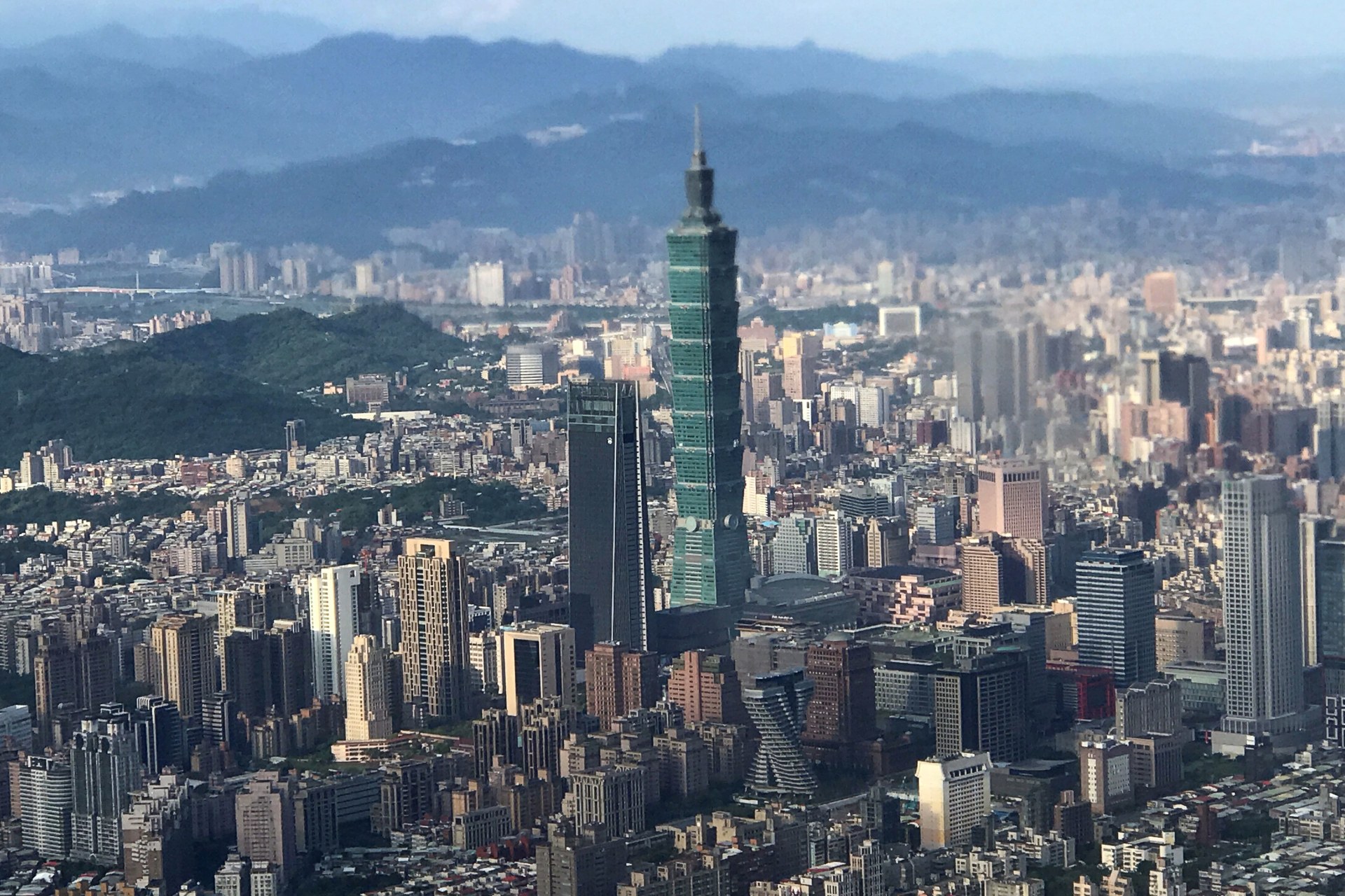<p>Nan Shan Plaza (L) and Taiwan’s landmark building Taipei 101 are pictured through the window of an airplane, in Taipei, Taiwan on August 19, 2018.</p>
