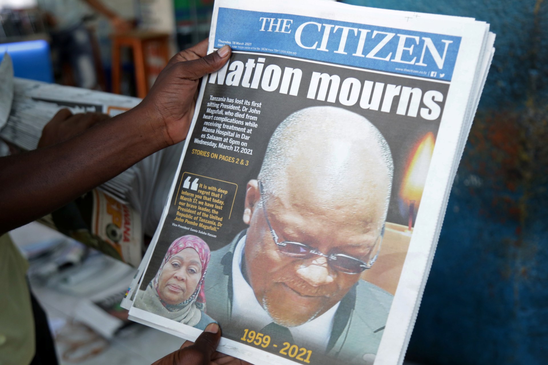 <p>A man holds a newspapers following the death of Tanzania’s President John Magufuli in Dar es Salaam, Tanzania on March 18, 2021.</p>
