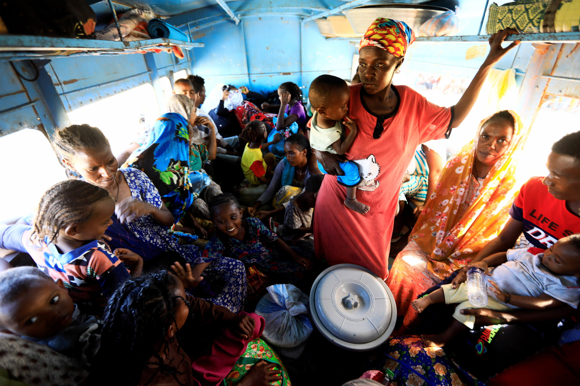 <p>Ethiopian refugees who fled Tigray region, sit inside a courtesy bus at the Fashaga camp as they are transferred to Um-Rakoba camp on the Sudan-Ethiopia border, in Kassala state, Sudan December 13, 2020.</p>
