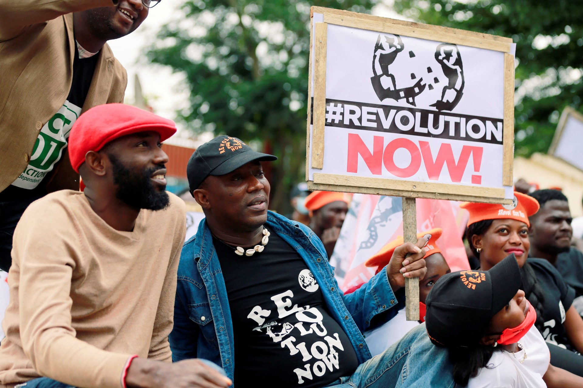 <p>Nigerian activist and former presidential candidate Omoyele Sowore sits with activists during a protest over fuel and power price rises, near the U.S. embassy in Abuja, Nigeria on October 1, 2020.</p>

