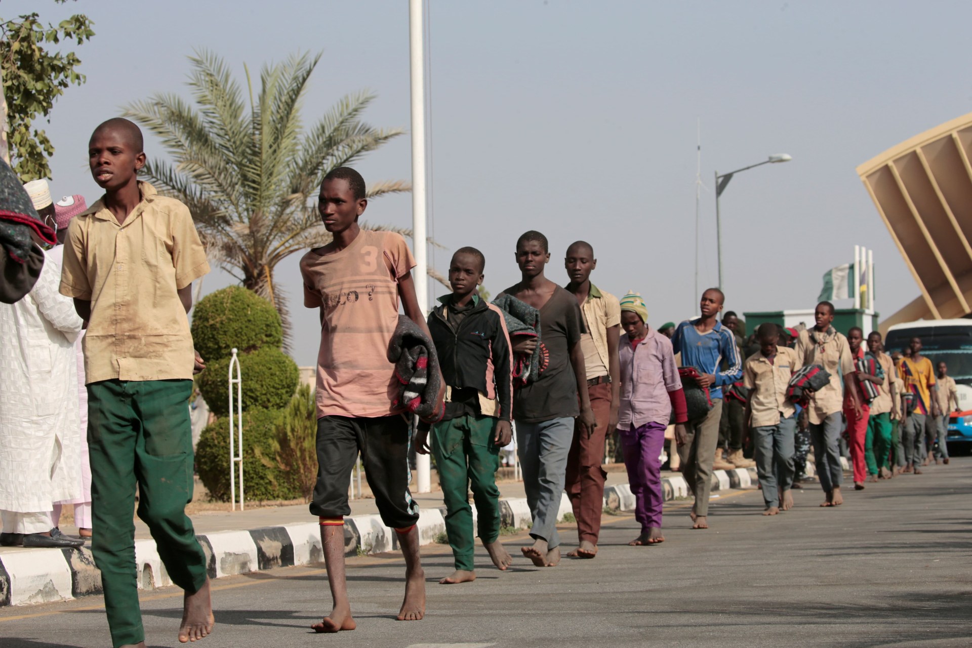 <p>Freed Nigerian schoolboys walk after they were rescued by security forces in Katsina, Nigeria on December 18, 2020.</p>