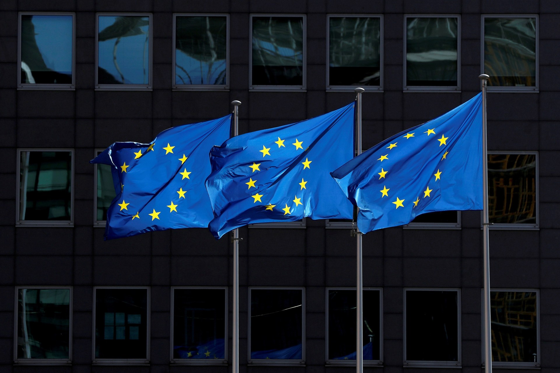<p>European Union flags flutter outside the European Commission headquarters in Brussels.</p>
