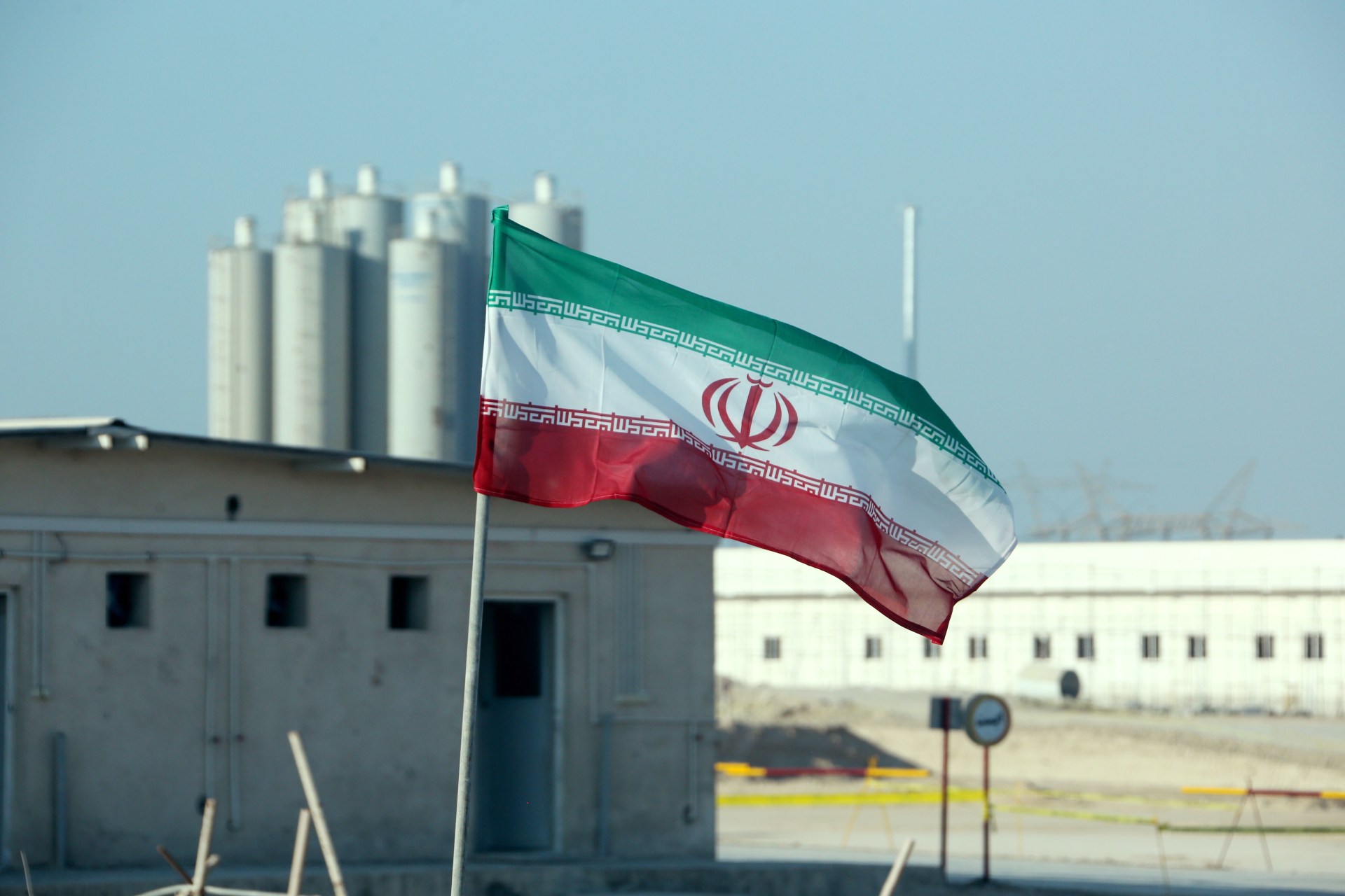 <p>The Iranian flag flies in front of the Bushehr nuclear power plant in Iran. </p>