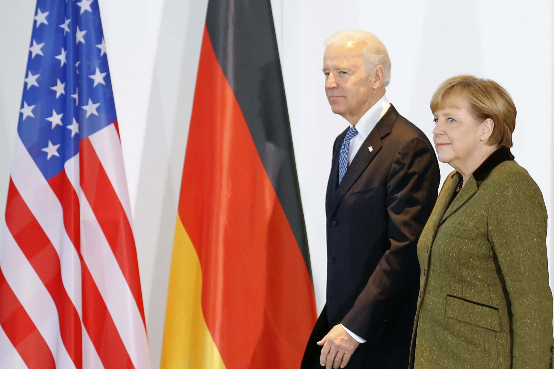 <p>Then-U.S. Vice President Joe Biden and German Chancellor Angela Merkel walk together in Berlin on February 1, 2013. </p>
