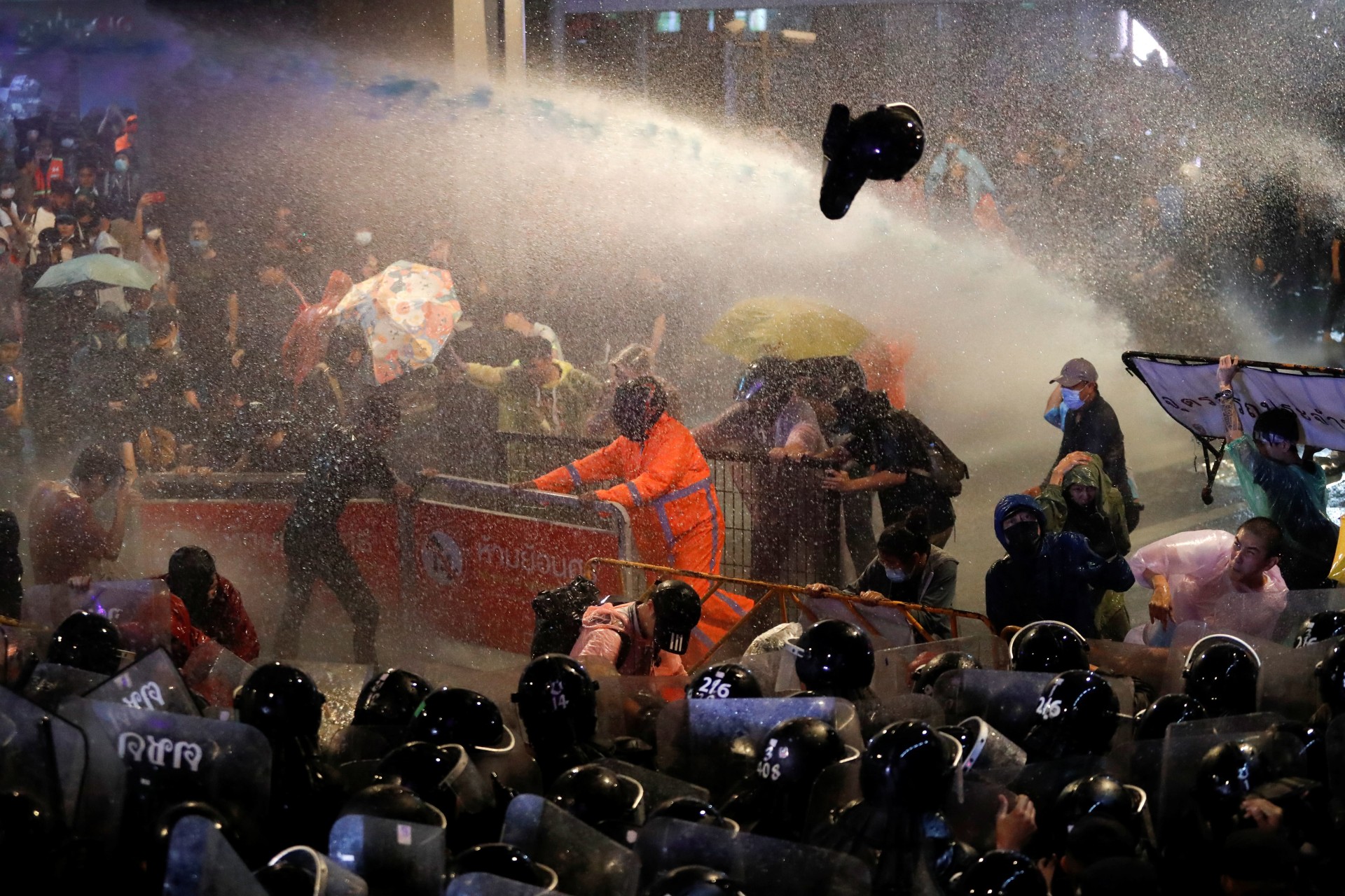 <p>People remove barricades blocking the road during an antigovernment protest, in Bangkok, Thailand on October 16, 2020.</p>