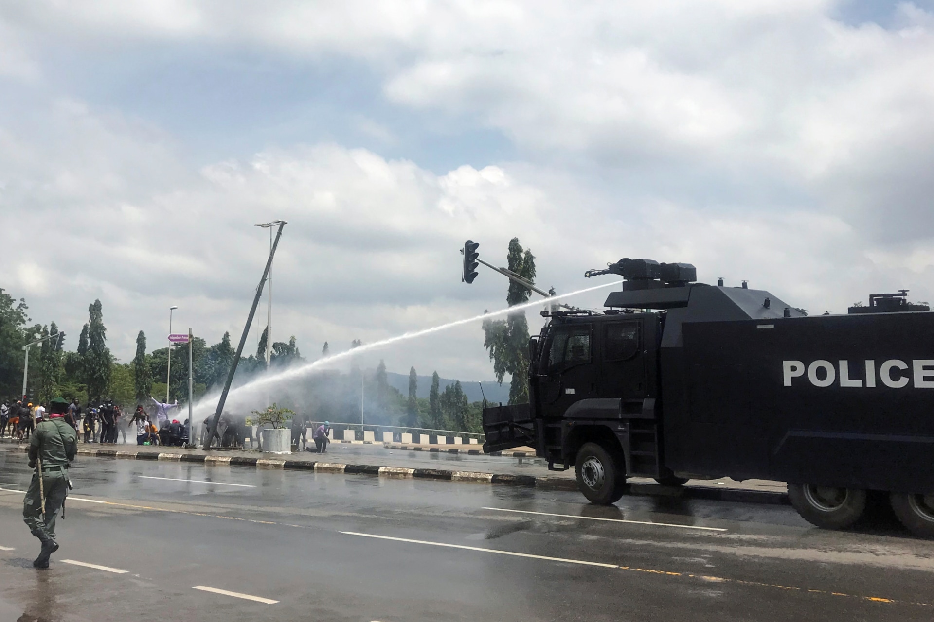 <p>Police use water cannons to disperse people protesting against alleged brutality by members of Nigeria’s Special Anti-Robbery Squad (SARS), in Abuja, Nigeria on October 11, 2020.</p>
