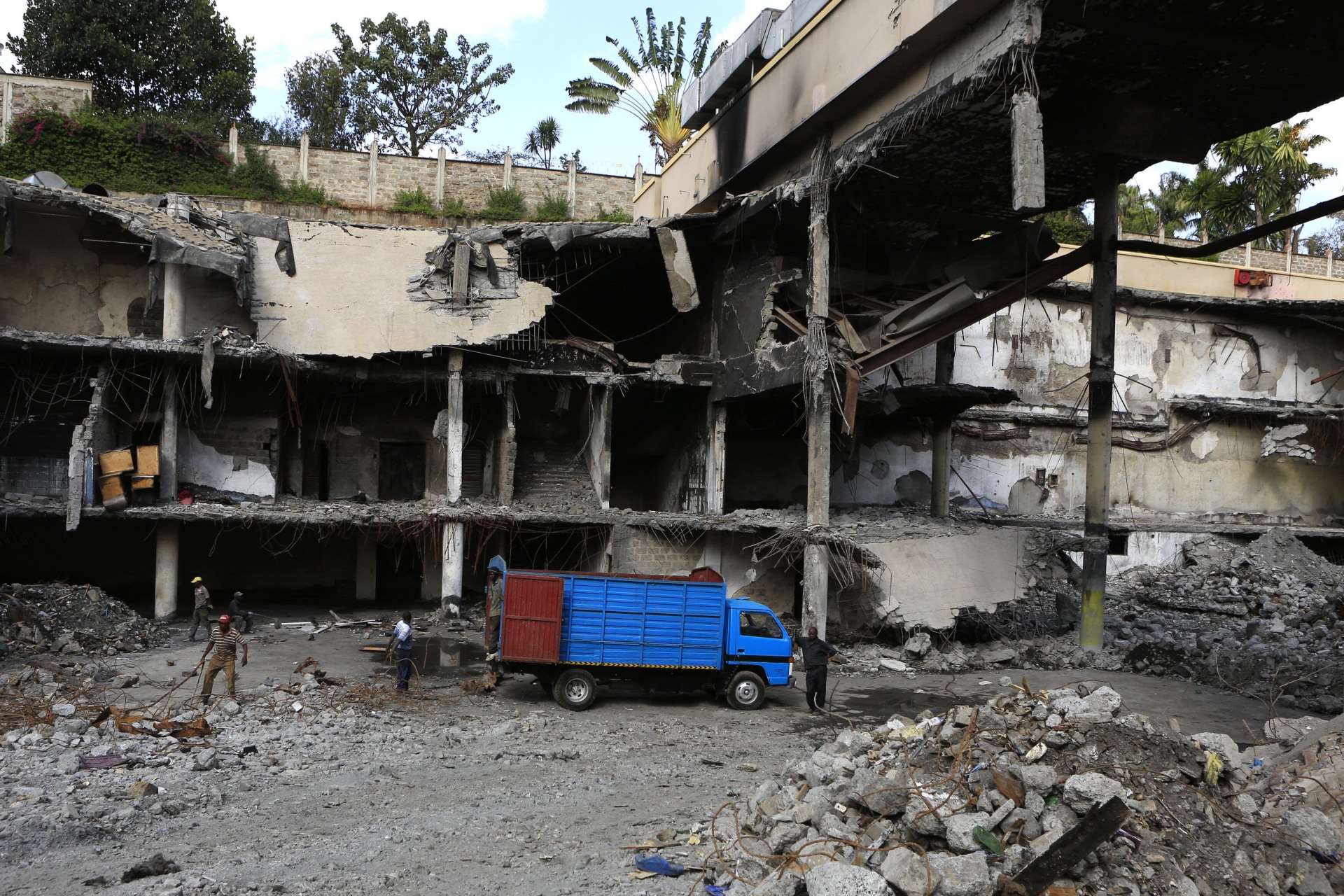 <p>Men work on a damaged section of the Westgate Shopping Mall, after al-Shabab militants launched an attack on the mall in September 2013, in Nairobi on January 21, 2014.</p>
