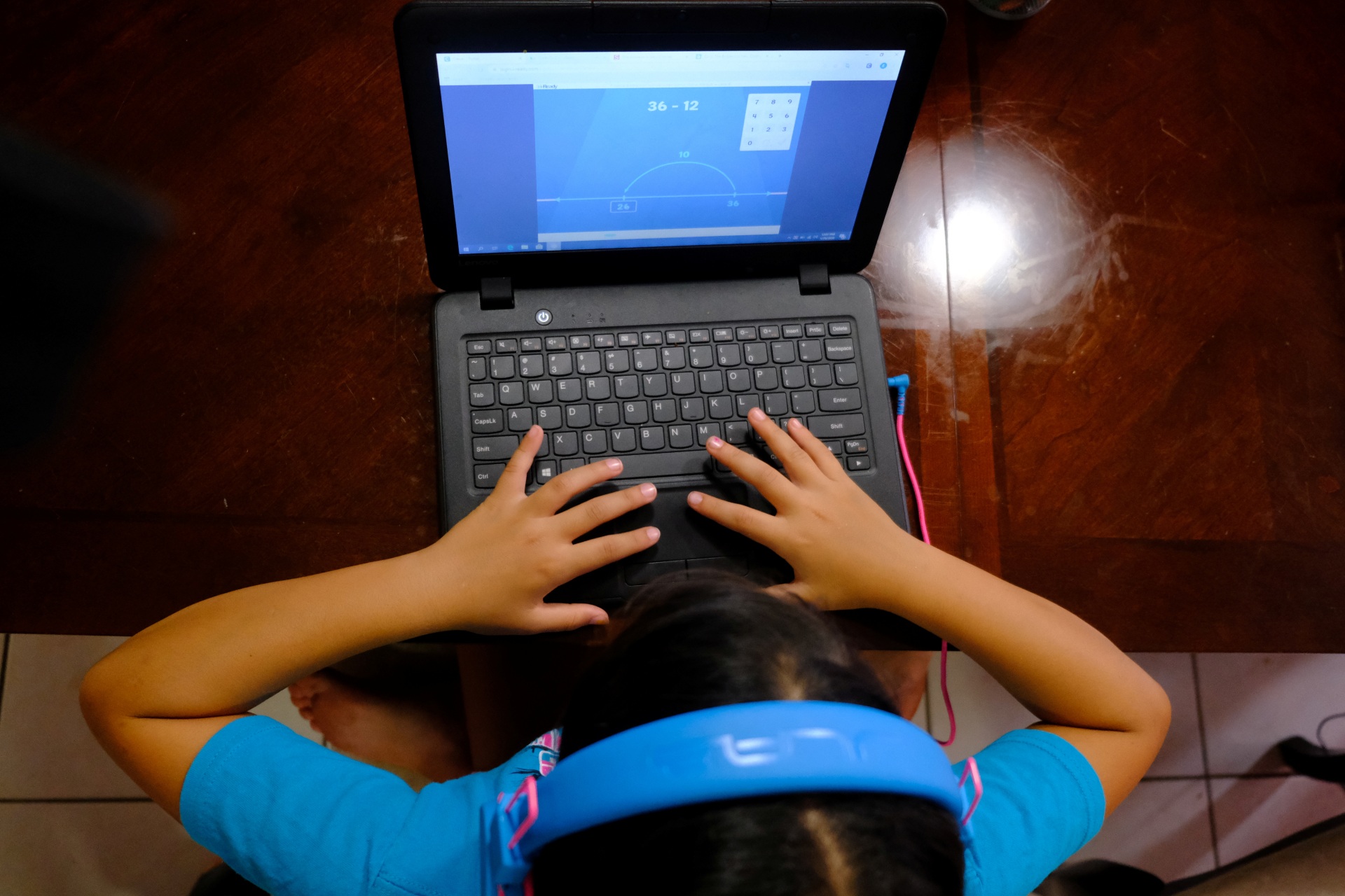 <p>A student completes homework from her computer in Broward County, Florida, United States. May 29, 2020.</p>