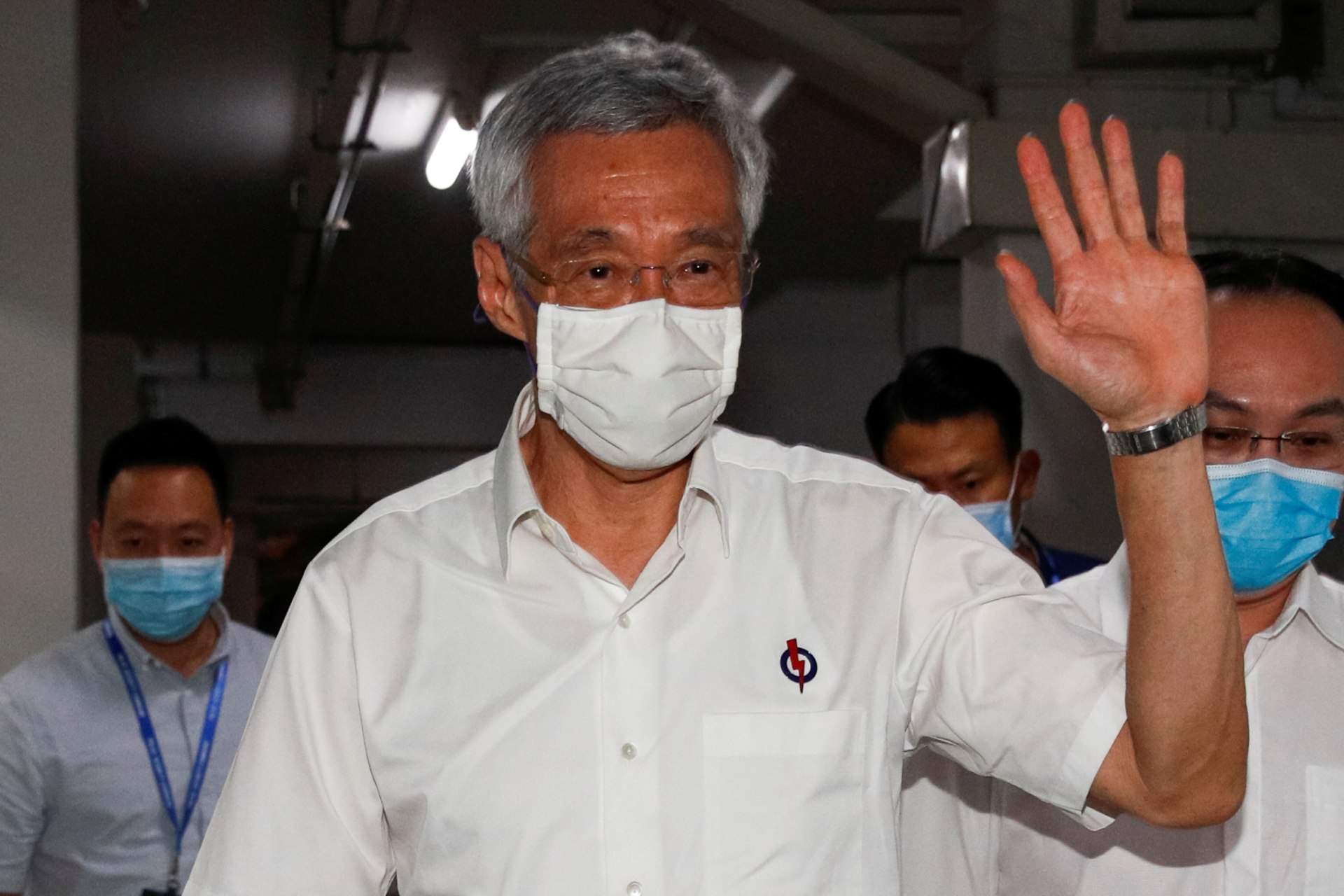 <p>Singapore’s Prime Minister Lee Hsien Loong waves as he arrives at a People’s Action Party branch office, as ballots are being counted during the general election, in Singapore on July 11, 2020.</p>