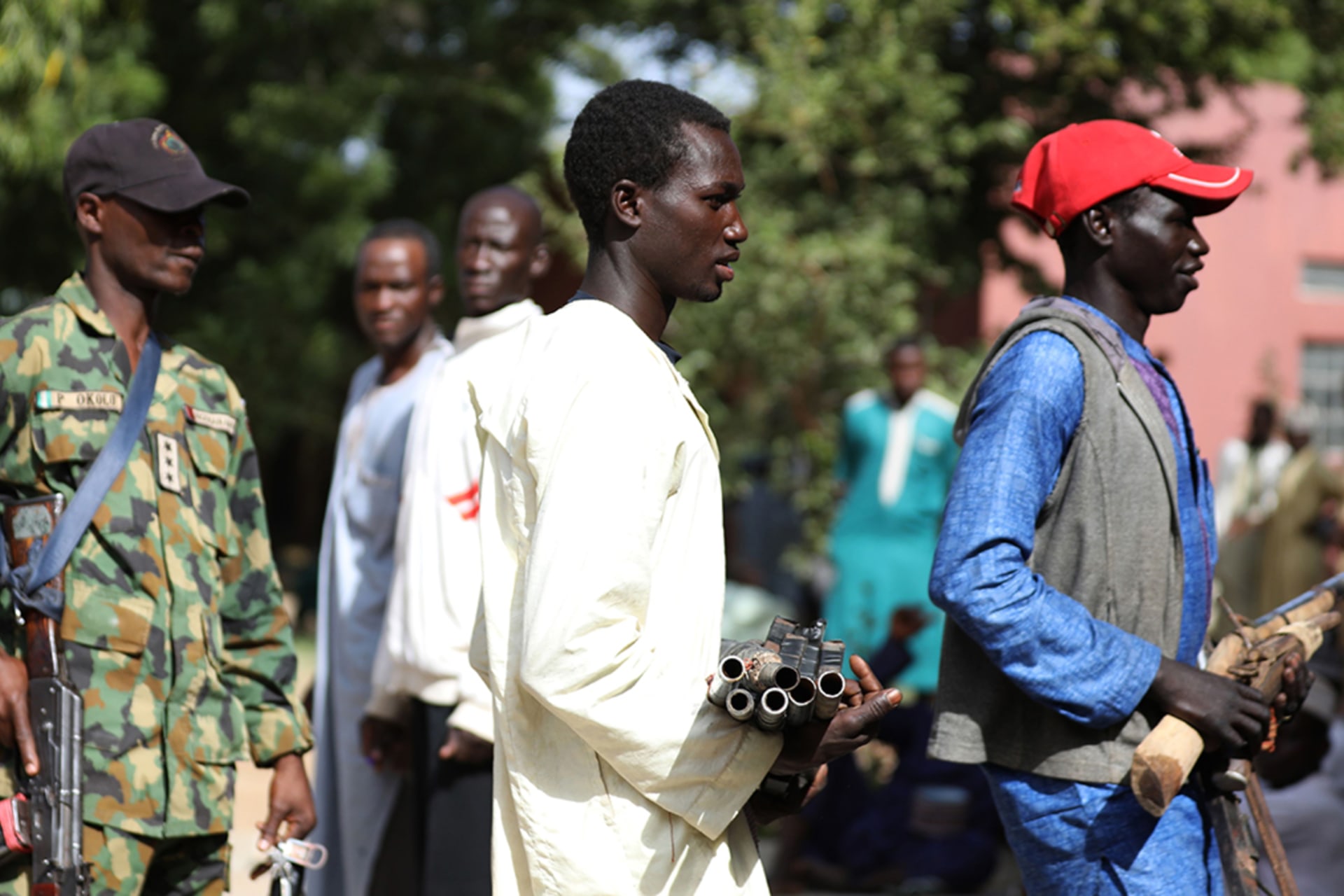 <p>Members of the Yansakai vigilante group bring their weapons into a government building as members surrendered more than five hundred guns to Zamfara Governor Bello Matawalle as part of a peace process, in Gusau, Zamfara, Nigeria, on December 3, 2019.</p>