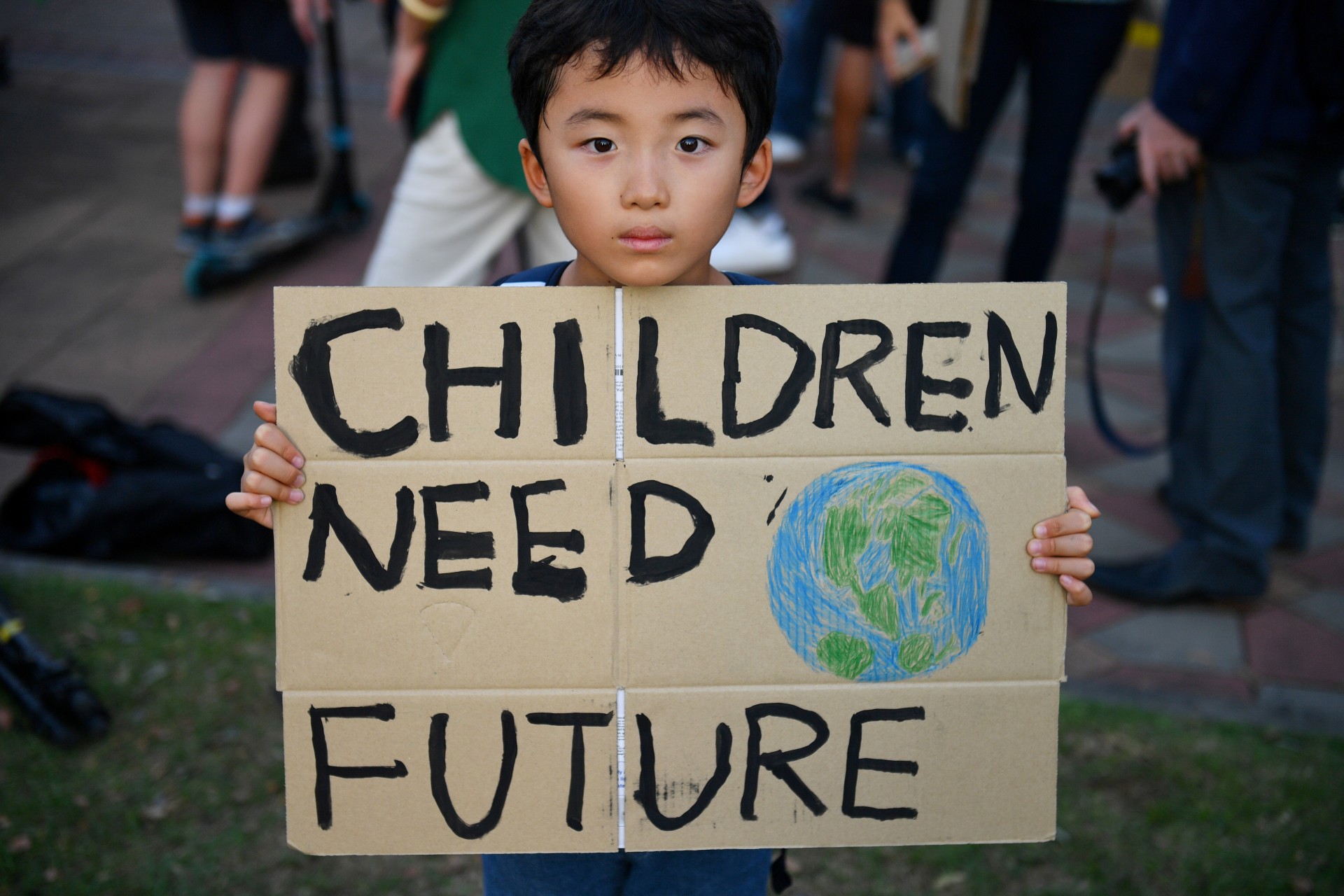 <p>A child holds a placard during a protest against climate change consequences in Bangkok, Thailand on November 29, 2019. </p>