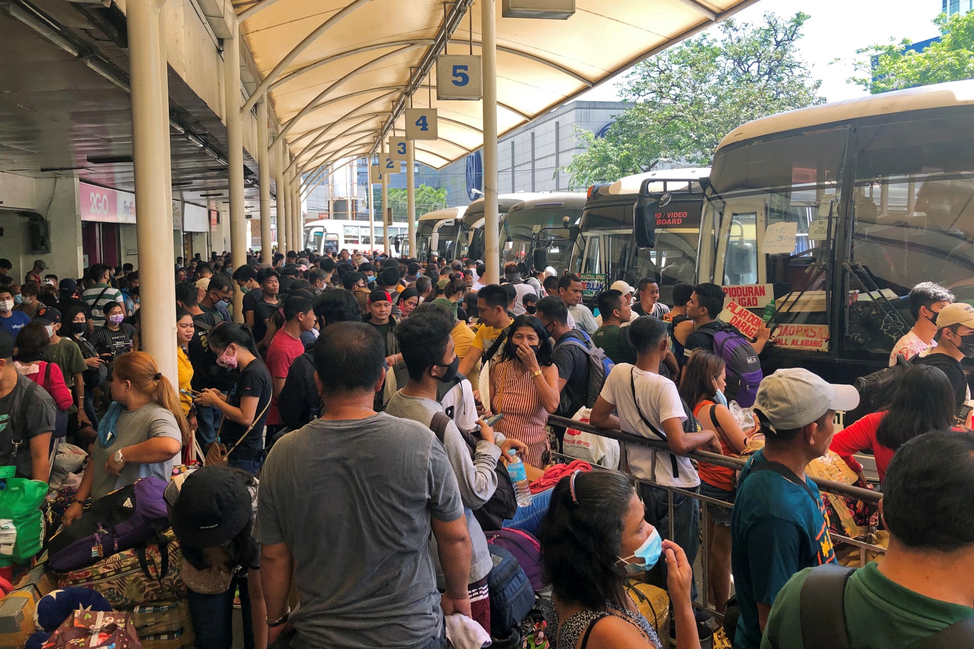 <p>Passengers wear protective masks while waiting at the Araneta Center Bus Terminal in Cubao, Quezon City, Philippines, on March 13, 2020, following President Rodrigo Duterte’s announcement of a local travel ban in the Philippine capital</p>
