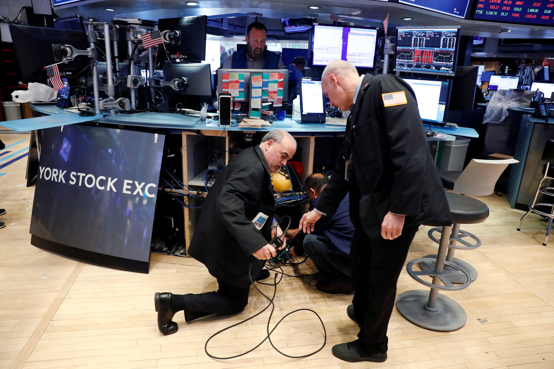 <p>Traders remove computer equipment to work from home on the floor of the New York Stock Exchange (NYSE).</p>