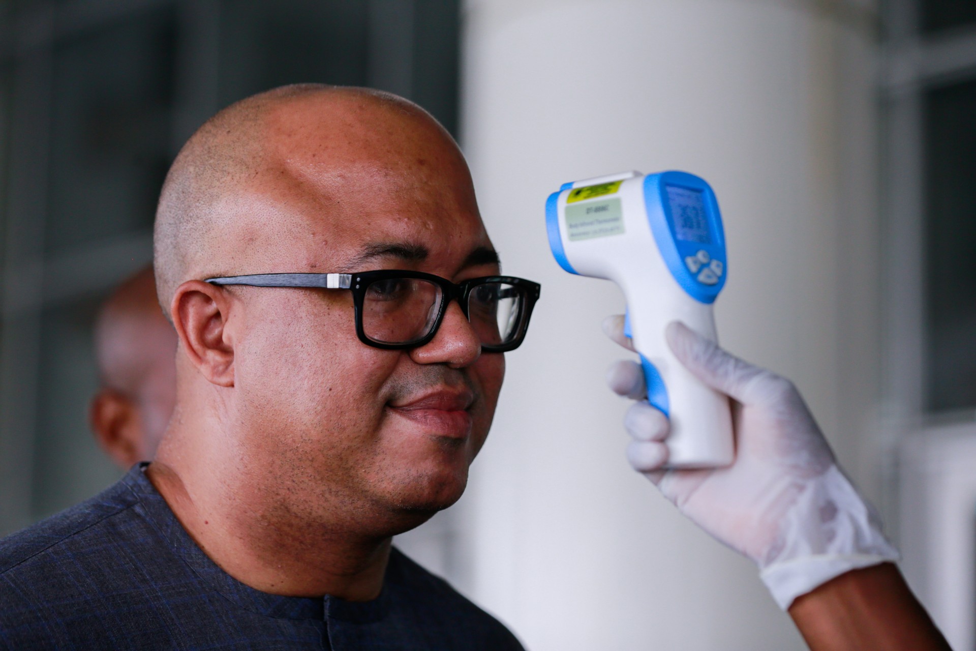 <p>Dr. Chikwe Ihekweazu, the Director General of the Nigeria Centre for Disease Control (NCDC) has his temperature checked during a diplomatic meeting at the Ministry of Foreign Affairs in Abuja, Nigeria, on March 12, 2020</p>
