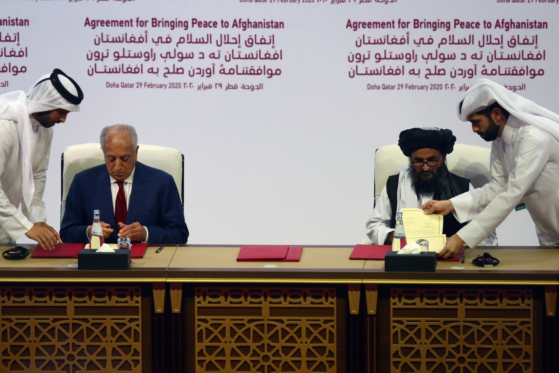 <p>Mullah Abdul Ghani Baradar, the leader of the Taliban delegation, signs an agreement with Zalmay Khalilzad, U.S. envoy for peace in Afghanistan, at a signing agreement ceremony between members of Afghanistan’s Taliban and the U.S. in Doha, Qatar. </p>